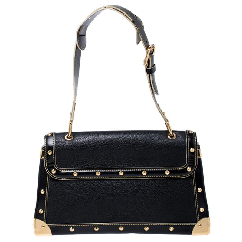 This Le Talentueux bag from Louis Vuitton is gorgeous. The black beauty is crafted from leather and flaunts a unique and distinctive style. It features beautiful gold-tone pyramid studs, a lock closure, rings and metal reinforced edges, all of which