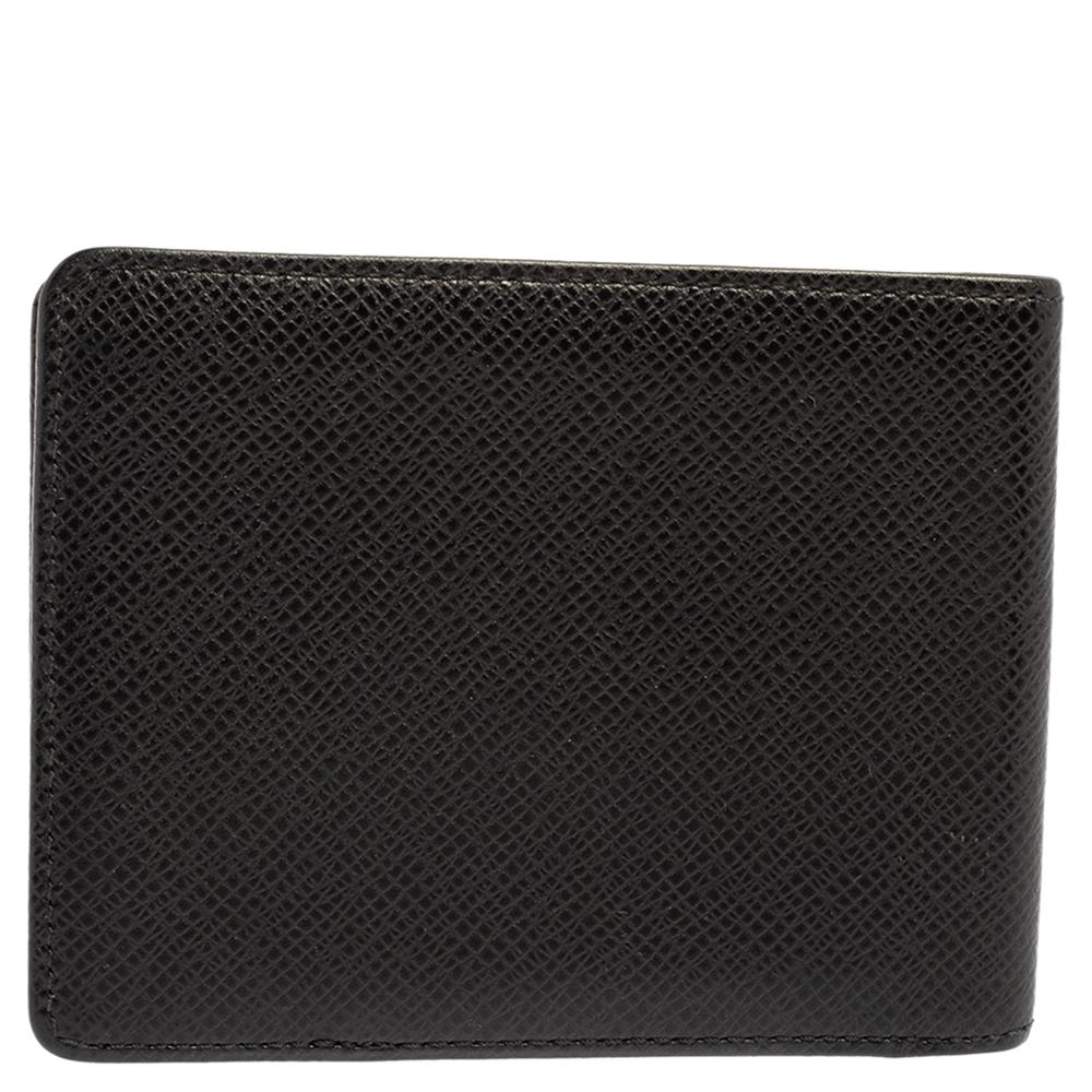 Showcasing an exclusive design from Louis Vuitton, this wallet makes for a convenient accessory. Featuring a Taiga leather exterior, this wallet is a convenient accessory. Characterized by a chic black shade, this wallet can fit in your essentials