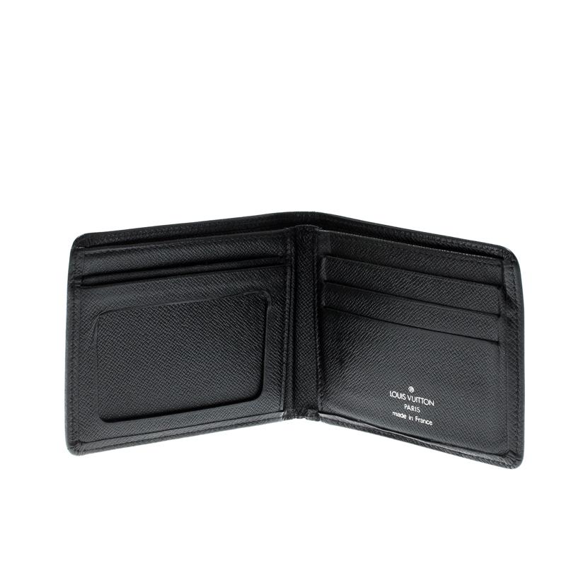Store your essentials effortlessly in this sturdy Taiga leather wallet. This piece is a suave creation from the famous house of Louis Vuitton. Featuring a rich black shade, this superb wallet will assist you with ease.

Includes: Original Box

