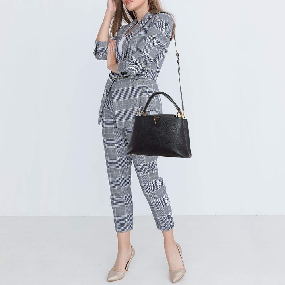 The Capucines is one of LVs most elegant bags. Crafted from Taurillon leather this bag features a structured design with a single handle and protective metal feet. While the front LV elevates its beauty the leather interior will dutifully hold all