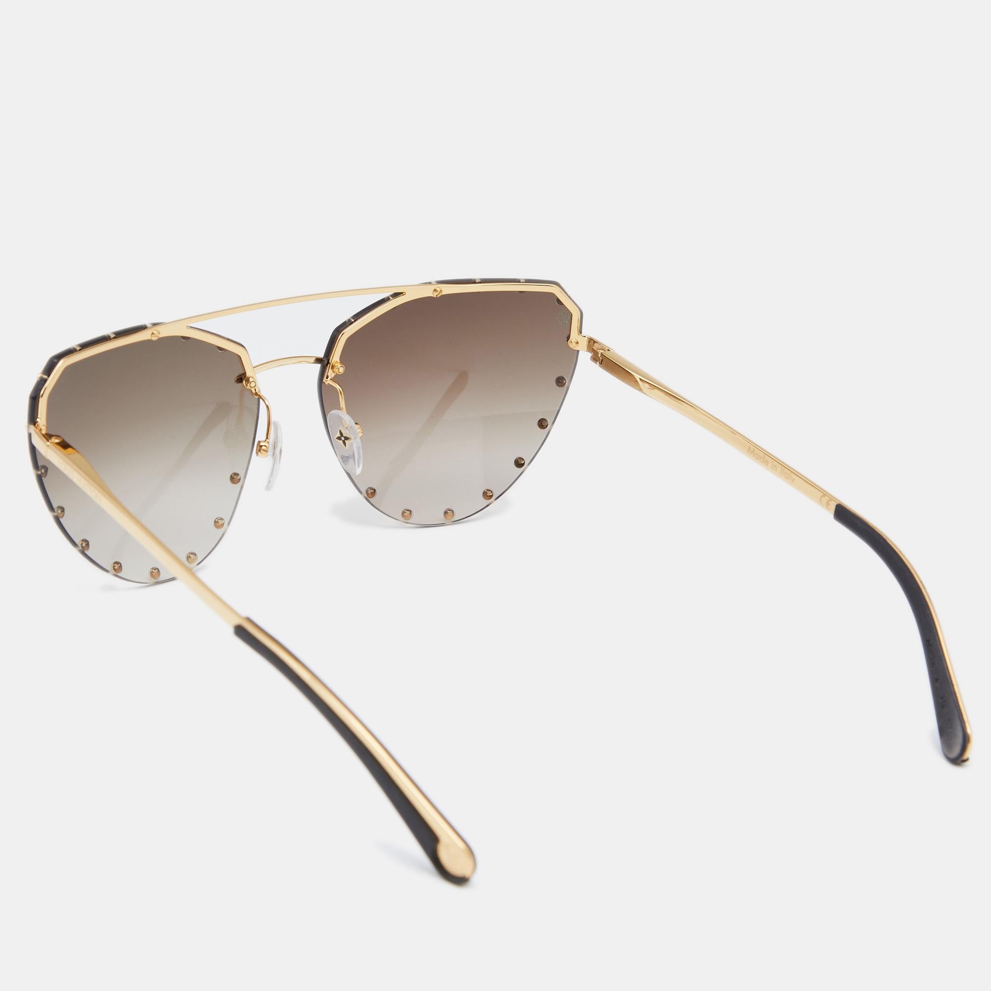 Add a statement finish to your look of the day with these Louis Vuitton The Party sunglasses. The design is set in a gold-tone metal frame, fitted with high-quality lenses, and adorned with LV-detailed studs.

Includes: Original Pouch, Original Case