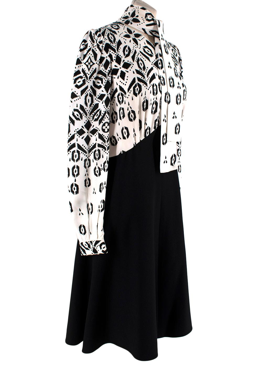 Louis Vuitton Black & White Geometric Pattern Midi Dress

- Long sleeve midi dress in black and white 
- Geometric abstract patterned bodice and block colour black skirt
- Self-tie bow to the collar
- Exposed back zip closure
- Partially