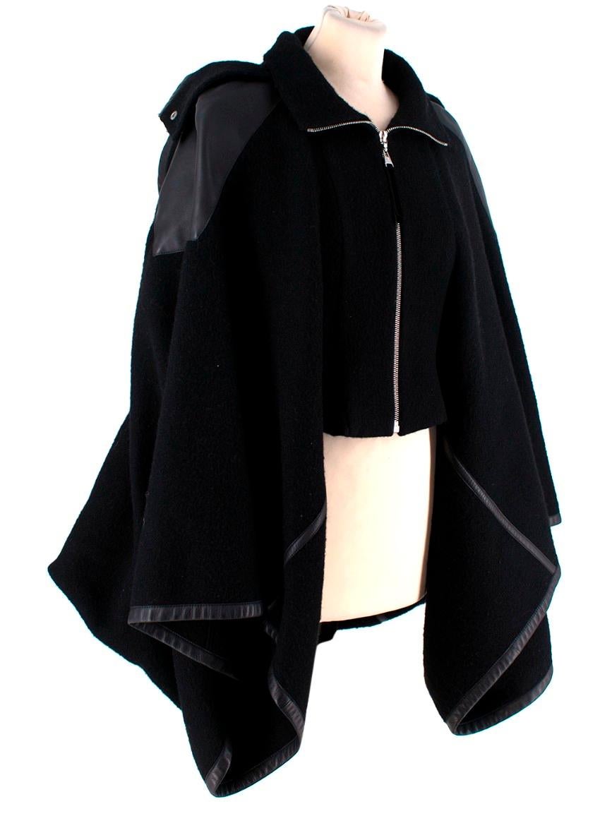 Louis Vuitton Black & Wool Calfskin Leather Trim Zip Hooded Cape
 

 - Draped, heavy wool felt, hooded cape, with leather shoulder panels and edging
 - Zip front, silver-tone metal hardware
 - Funnel neck, removable hood
 

 Materials:
 93% Wool
 7%