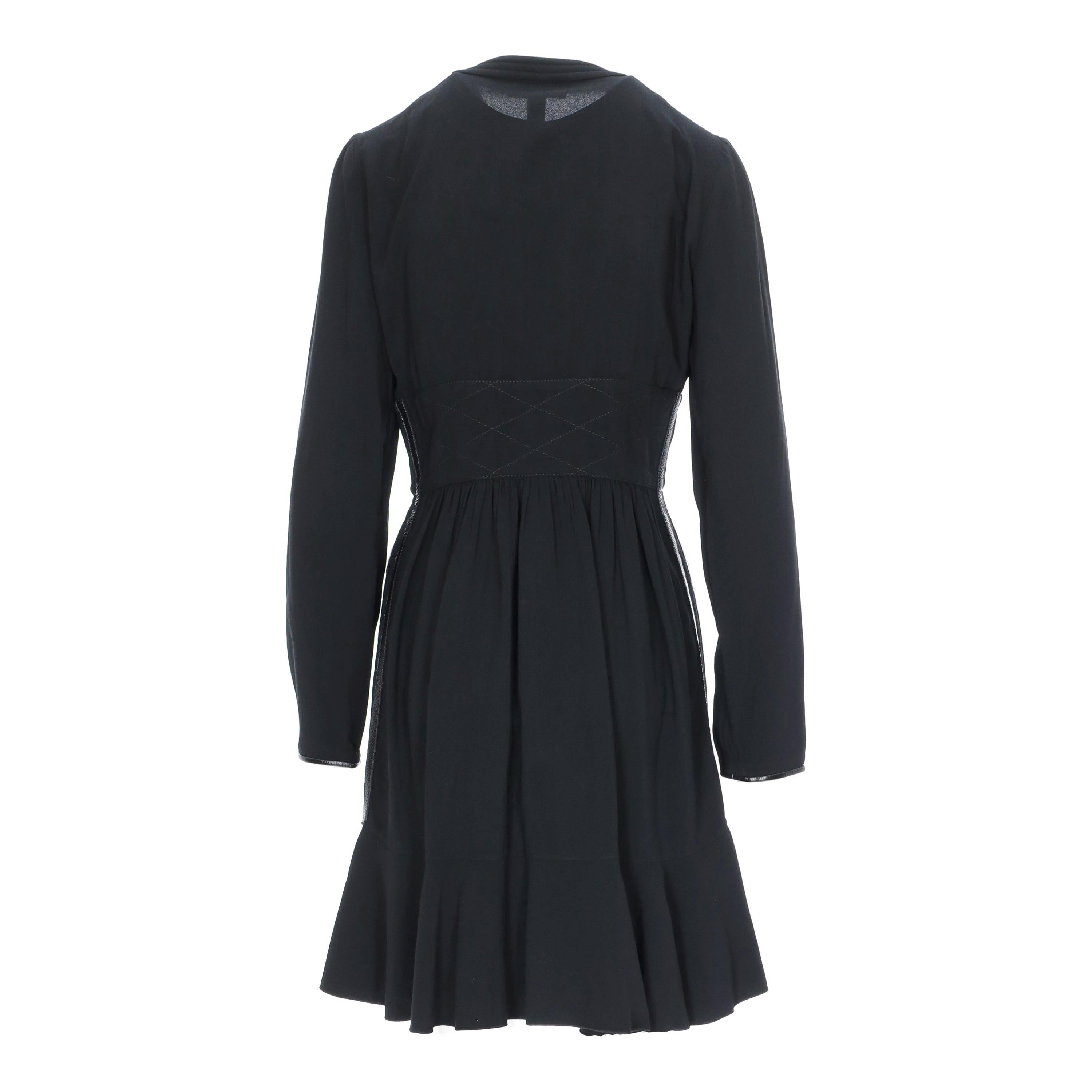 Crafted in monogrammed LV zipper that goes all the way down the front, this little black dress features a full sleeve, a crew neck, and piping panels on the sides and hem. The dress is finished off with frilly detailing on the hemline and