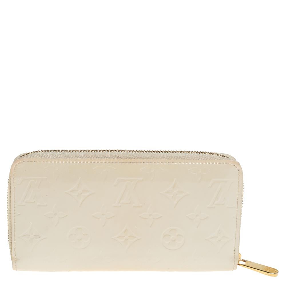 This Louis Vuitton Zippy wallet is conveniently designed for everyday use. Crafted from Monogram Vernis leather, the wallet has a zip closure that opens to reveal multiple slots, leather-lined compartments and a zip pocket for you to neatly arrange
