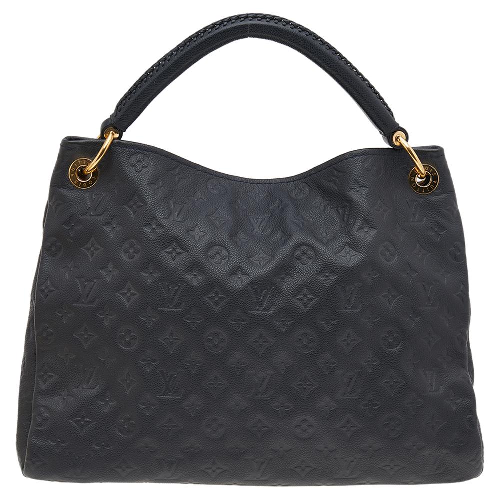 Flaunt this Louis Vuitton Artsy bag like a fashionista! Crafted from their signature Infini Monogram Empreinte leather, this bag features an open top that reveals a canvas-lined interior, spacious enough to carry all your essentials. The bag is