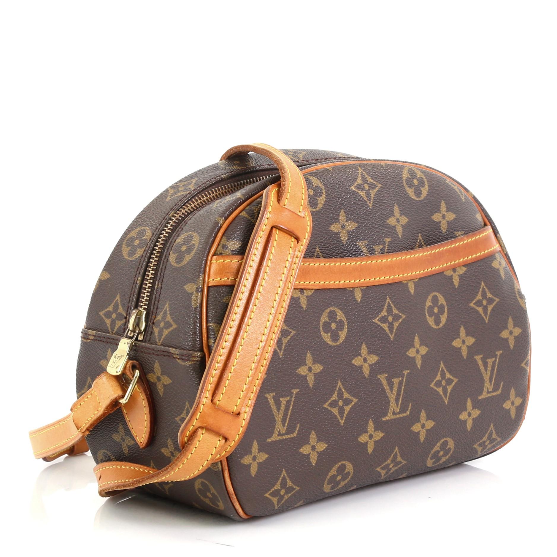 This Louis Vuitton Blois Handbag Monogram Canvas, crafted from brown monogram coated canvas, features adjustable leather shoulder strap, exterior front pocket, vachetta leather trim, and gold-tone hardware. Its zip closure opens to a brown leather