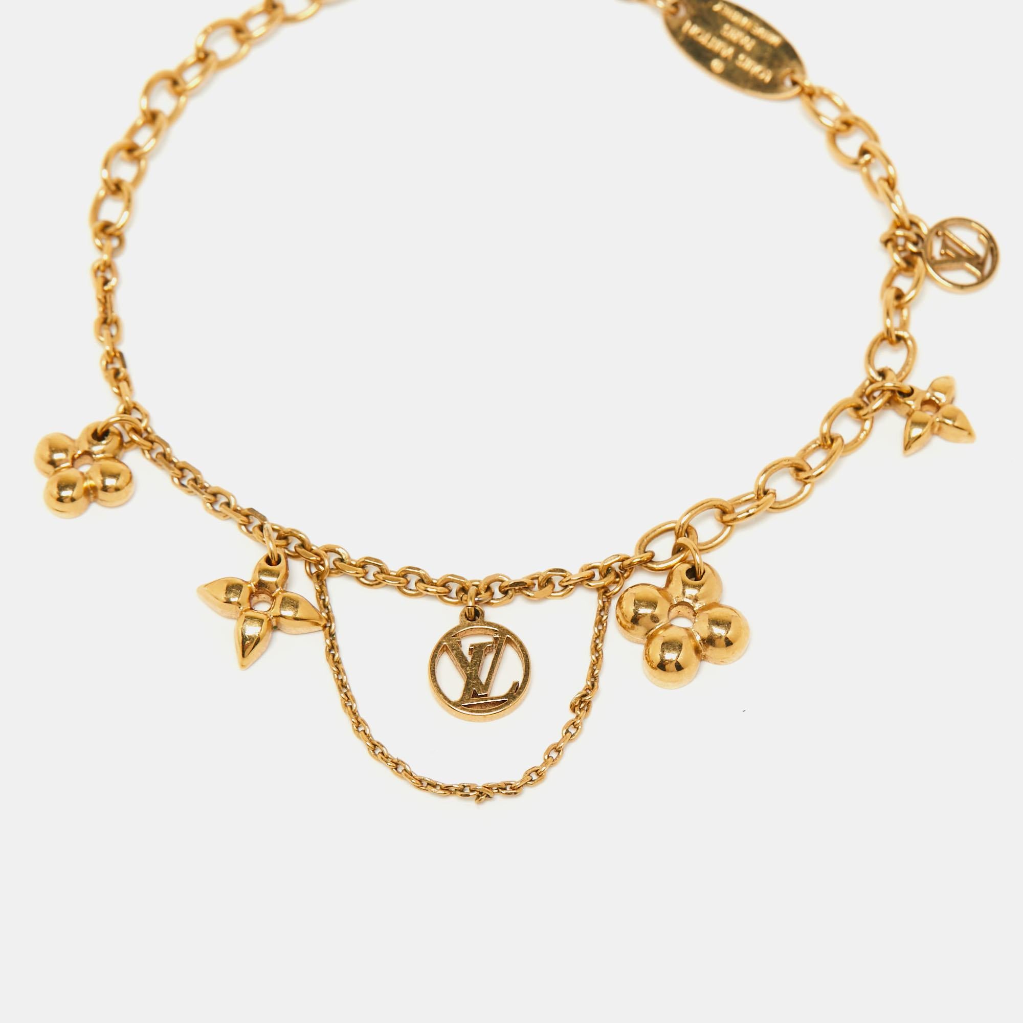 Louis Vuitton offers this beautiful bracelet to complement your style. ​Crafted from gold-tone metal, it has signature charms and the famous LV logo. The Blooming Supple bracelet fixes around the wrist with a lobster clasp.

Includes: Original Pouch
