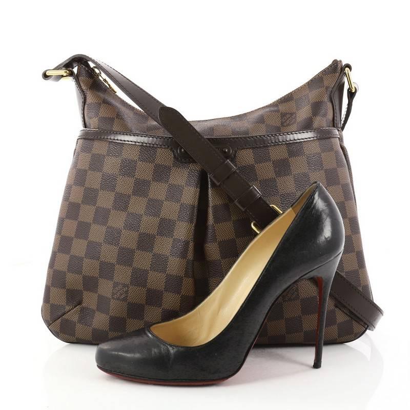 This authentic Louis Vuitton Bloomsbury Handbag Damier PM is a feminine yet versatile everyday bag made for the modern woman. Constructed from damier ebene coated canvas, this luxurious bag features an adjustable shoulder strap, dark brown leather