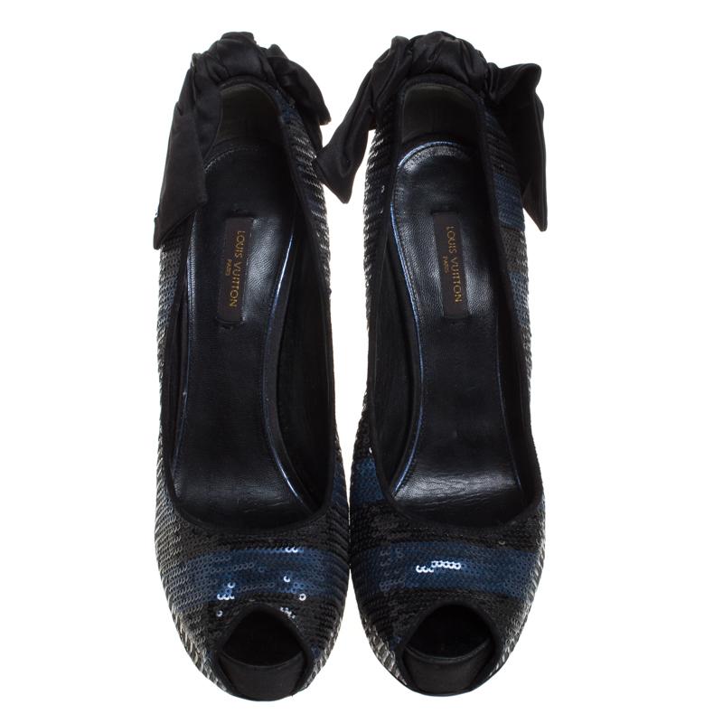 Perfect for all seasons, this pair of Louis Vuitton pumps are just what you need. These pumps are crafted in Italy and made from blue-black sequins that add a touch of glamour. They are styled with peep toes, platforms, 14.5 cm heels and bow detail