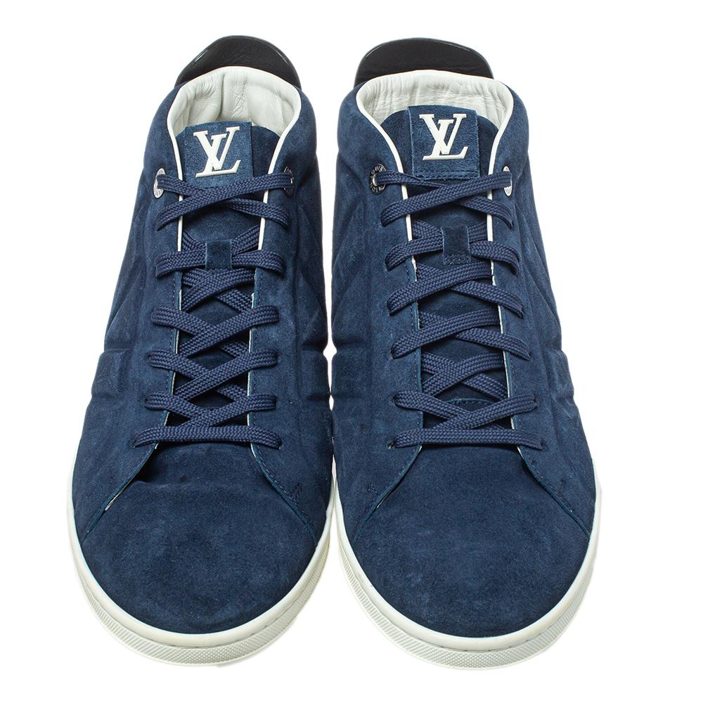 A pair that will see you through a long day in full comfort! Crafted using suede and leather, these Louis Vuitton sneakers are designed in a high-top style with lace-up closure along the front. The sneakers are finished with 'V' embossing and rubber