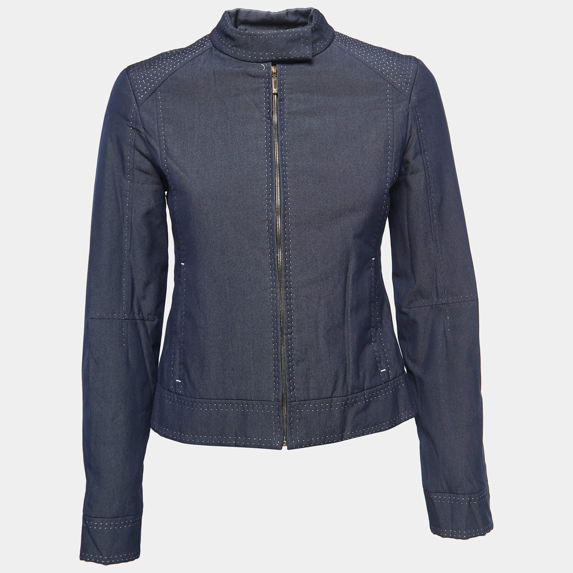 The Louis Vuitton jacket is a stylish and sophisticated outerwear piece. Crafted from premium chambray fabric, it features a sleek zip-front closure, creating a contemporary look. The jacket's elegant design is complemented by the iconic Louis