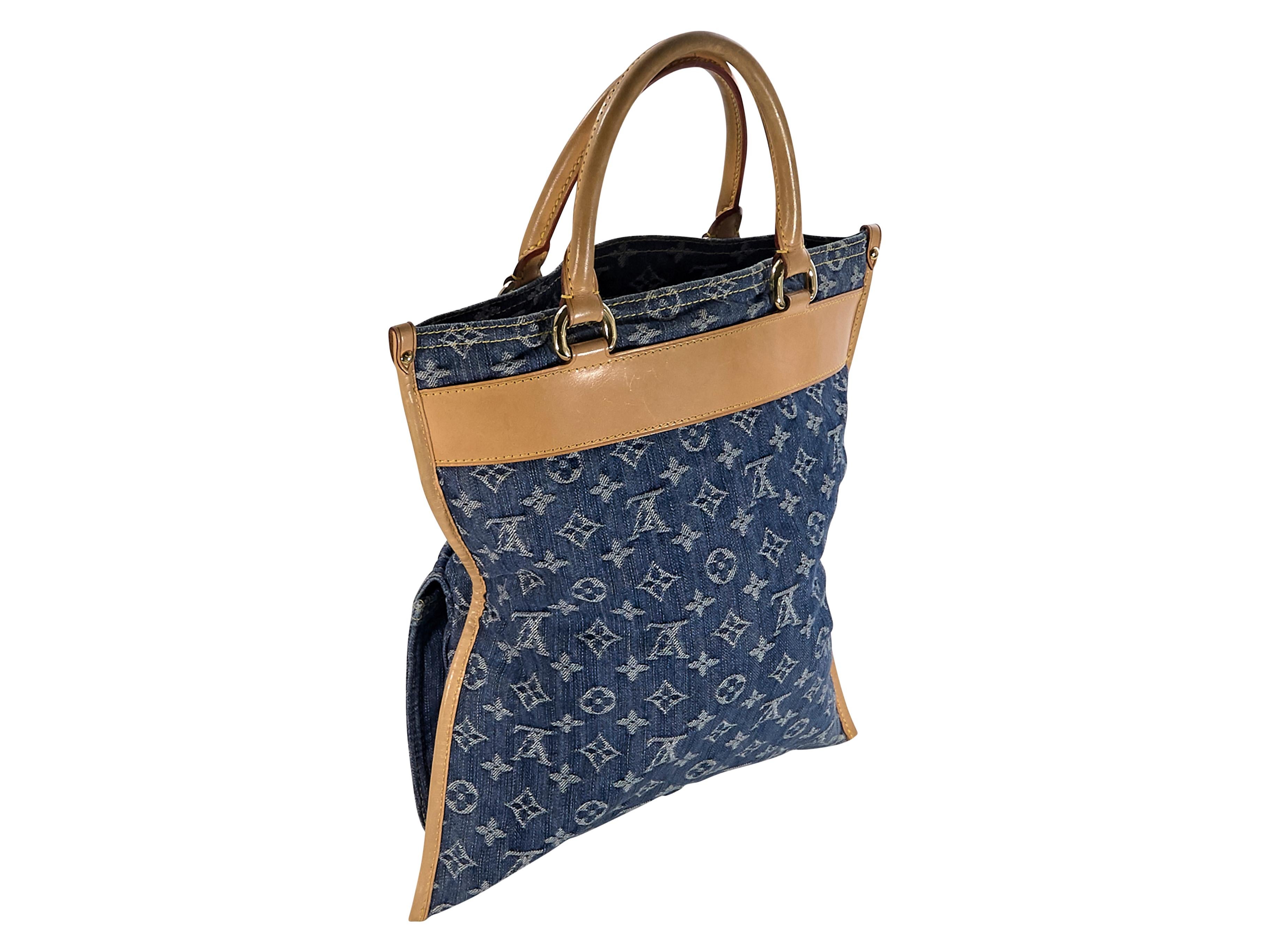 Product details:  Blue denim Sac Plat monogram tote bag by Louis Vuitton.  Trimmed with tan leather.  Dual carry handles.  Open top.  Lined interior with inner slide pocket.  Exterior zip and clasp flap pockets.  Goldtone hardware.  13 
