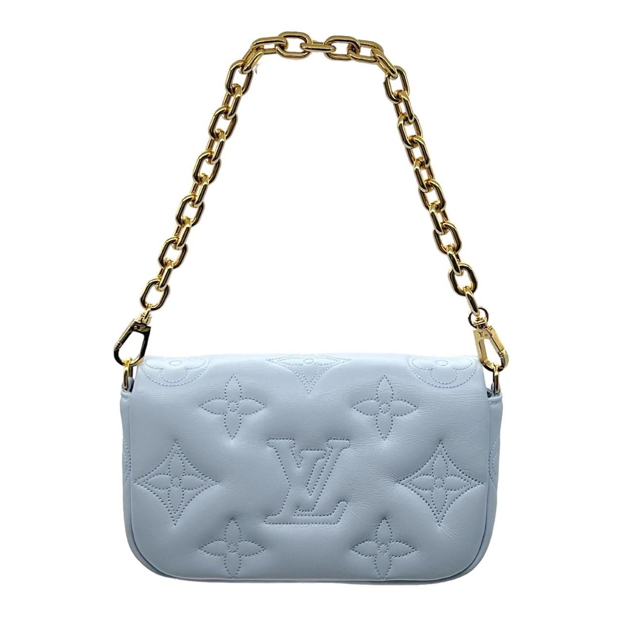 We are offering this trendy Louis Vuitton Wallet on Strap Bubblegram in the Blue Glacier color. Made in Italy, this bag is finely crafted of a padded calfskin leather exterior with an embroidered Louis Vuitton Monogram pattern. It has a removeable