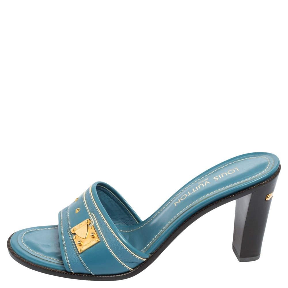 Step out with utmost style and confidence wearing these Louis Vuitton sandals. They come in a gorgeous blue shade and are made using leather. Gold-tone embellishments on the front straps and heels elevate their fashionable appeal. Pair the slides