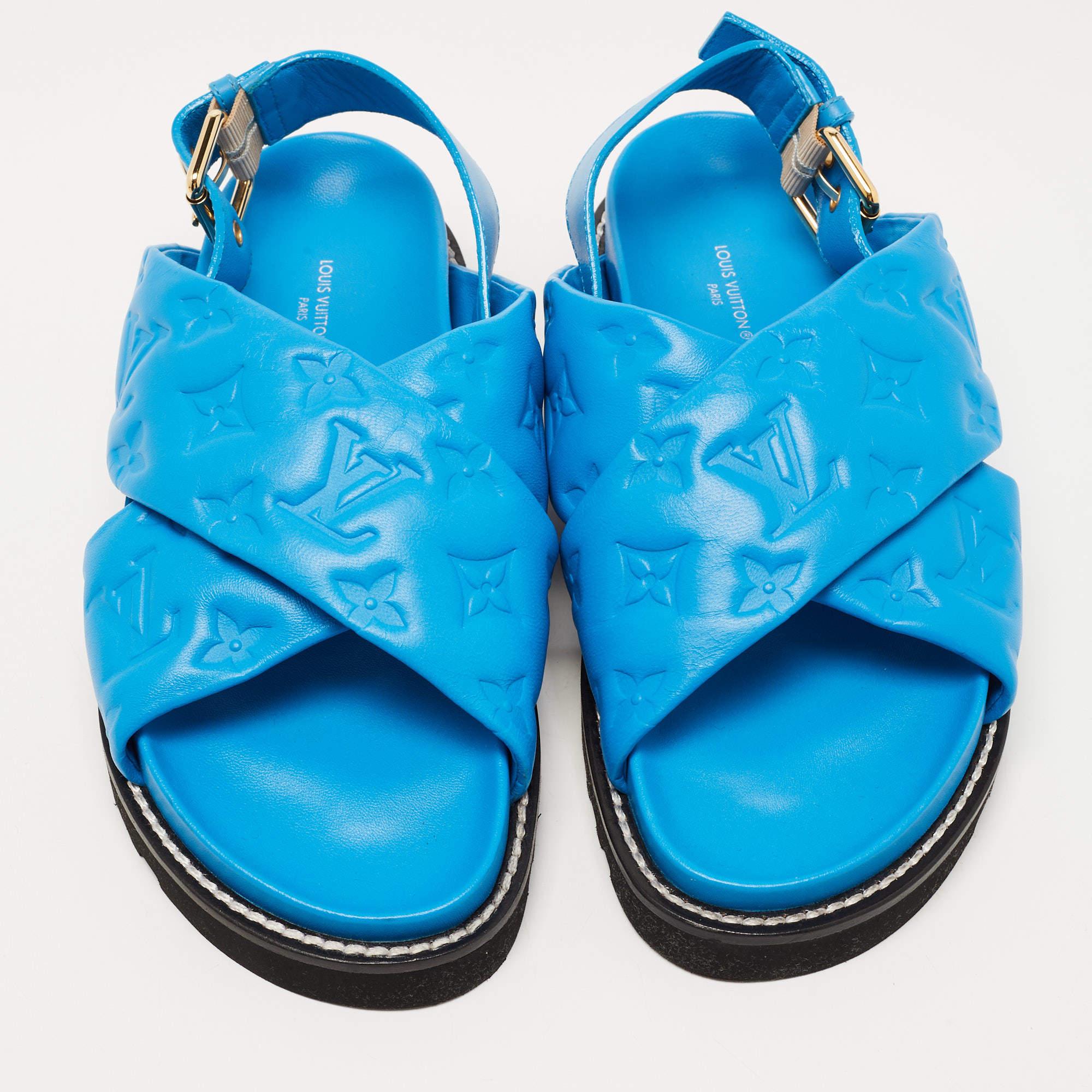 Crafted from premium blue leather, these sandals feature a sleek sling-back design for a secure fit. With their comfortable soles and signature Louis Vuitton branding, they effortlessly combine fashion and comfort for the modern woman.

Includes:
