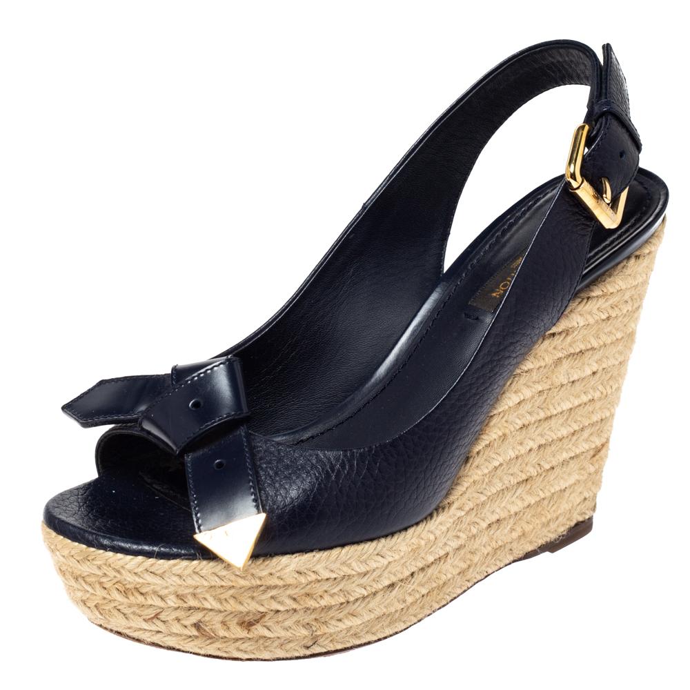 Wear them through the day or dress them up for day time parties, these Louis Vuitton open toe sandals are stylish and comfortable. With a blue leather surface that features knot details at the vamp, these shoes feature espadrille wedges that give