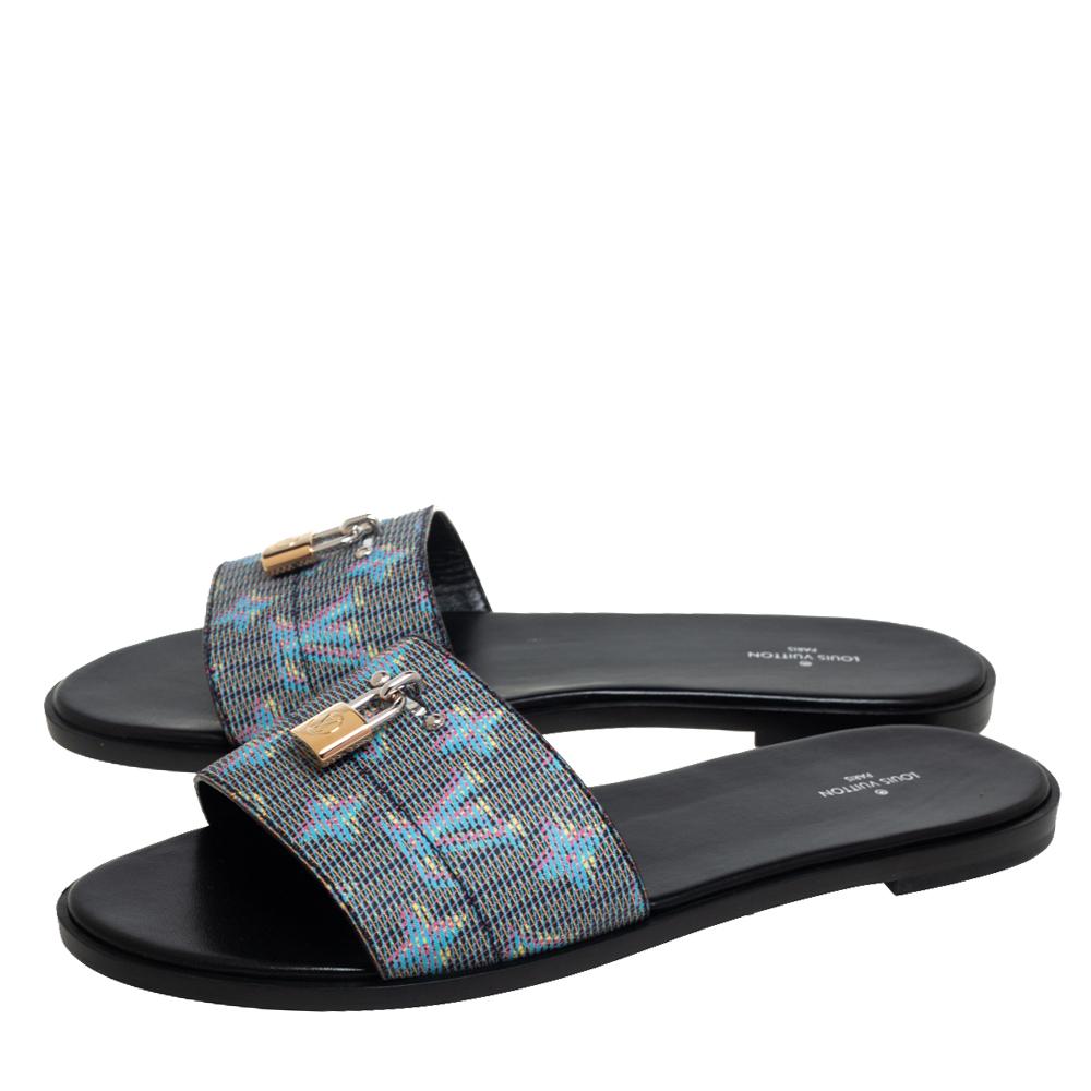 These Lock-It sandals from Louis Vuitton are a gift of comfort and style you cannot refuse! They have been crafted from pop monogram-coated canvas and styled in an open toe silhouette. The vamps are creatively detailed with a silver-tone LV padlock