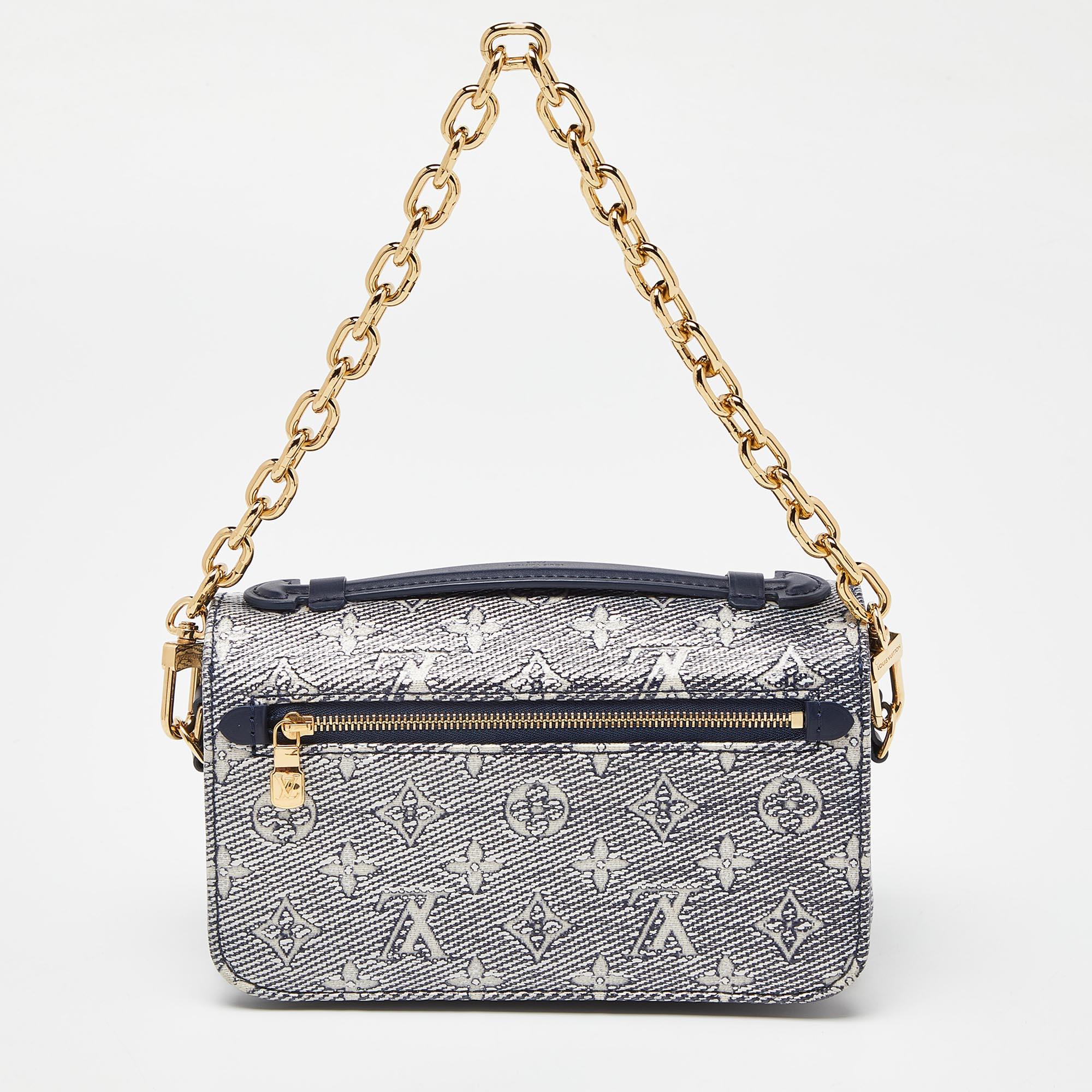 Crafted from Louis Vuitton's iconic blue monogram canvas, the Pochette Metis East West Bag exudes timeless elegance. With its sleek silhouette and gold-tone hardware, it effortlessly combines style and functionality. The spacious interior and