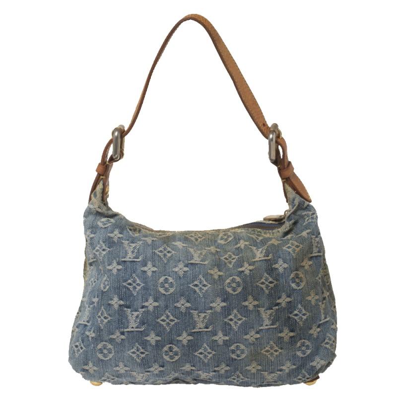 Complete your look with this stylish Baggy PM bag from Louis Vuitton. Crafted in France, it is made from blue monogram denim and leather. This beautiful bag features an adjustable flat leather handle, two buckled pockets, and a zip pocket at the