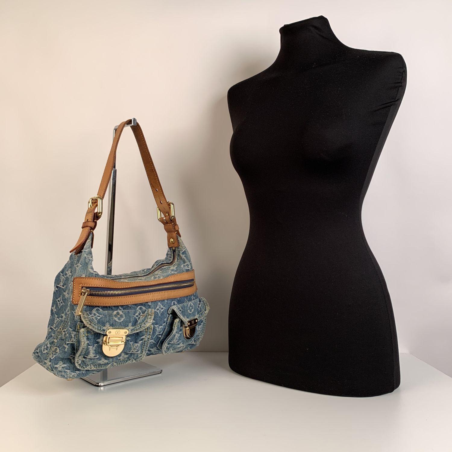 Casual Louis Vuitton Monogram Denim 'Baggy Pm' Shoulder bag. The bag is crafted in light blue monogram denim with tan leather trim and shoulder strap. Gold metal hardware. 2 gusseted pockets with push-lock closures and 1 front zip pocket. Upper