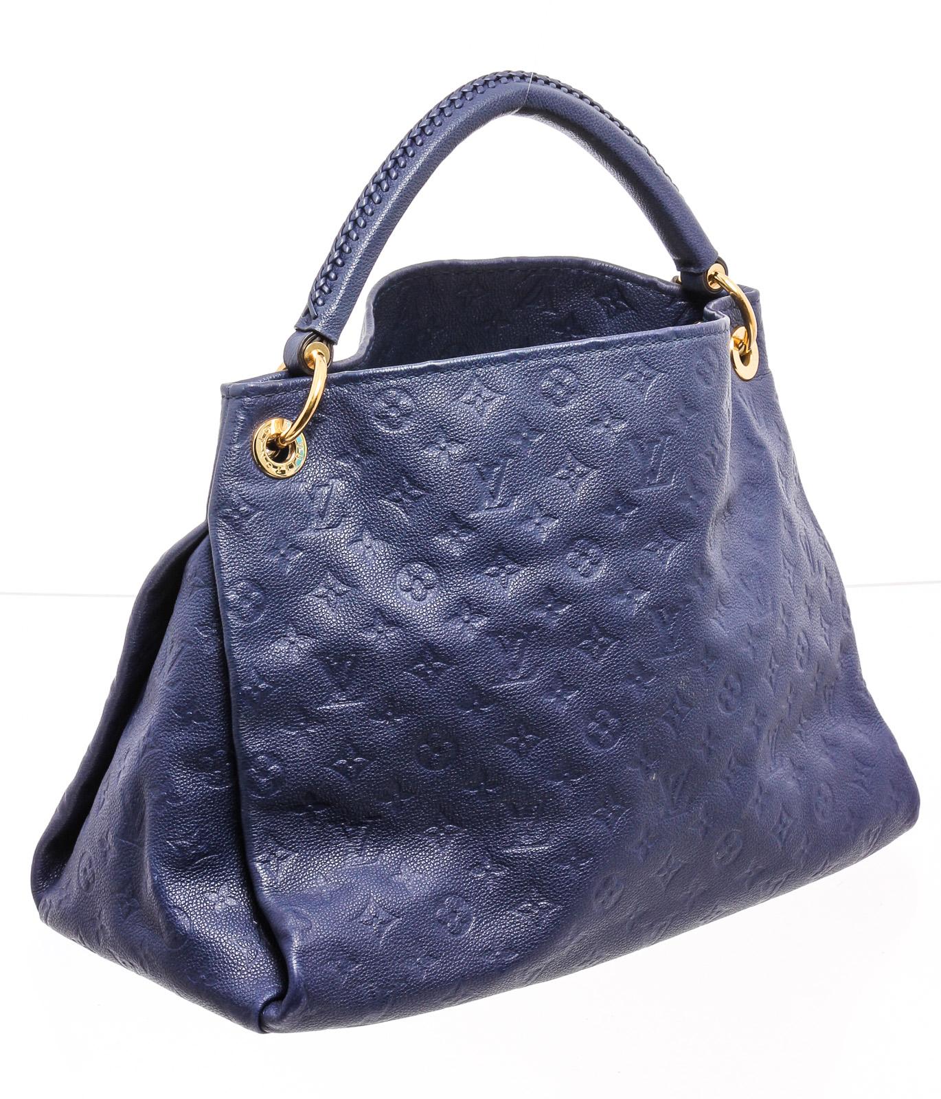 Blue Empreinte leather Louis Vuitton Artsy MM with brass hardware, rolled top handle featuring whipstitched detail, tonal striped canvas lining, seven pockets at interior walls; one with zip closure and open top.

22591MS