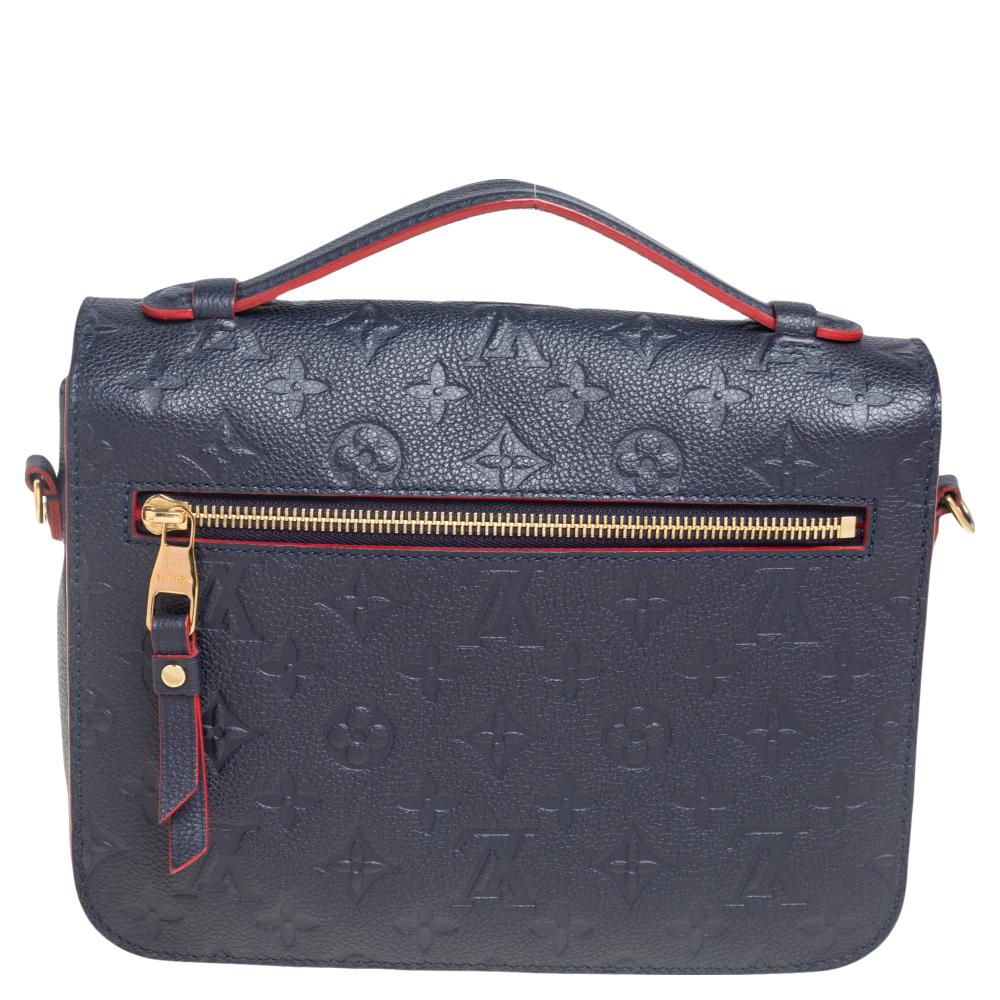 This attractive Louis Vuitton Pochette Metis Bag is a statement of luxury. Fashioned in Monogram Empreinte leather, this piece is styled with a gold-tone push-lock closure on the flap. A top handle and a detachable shoulder strap complete the chic