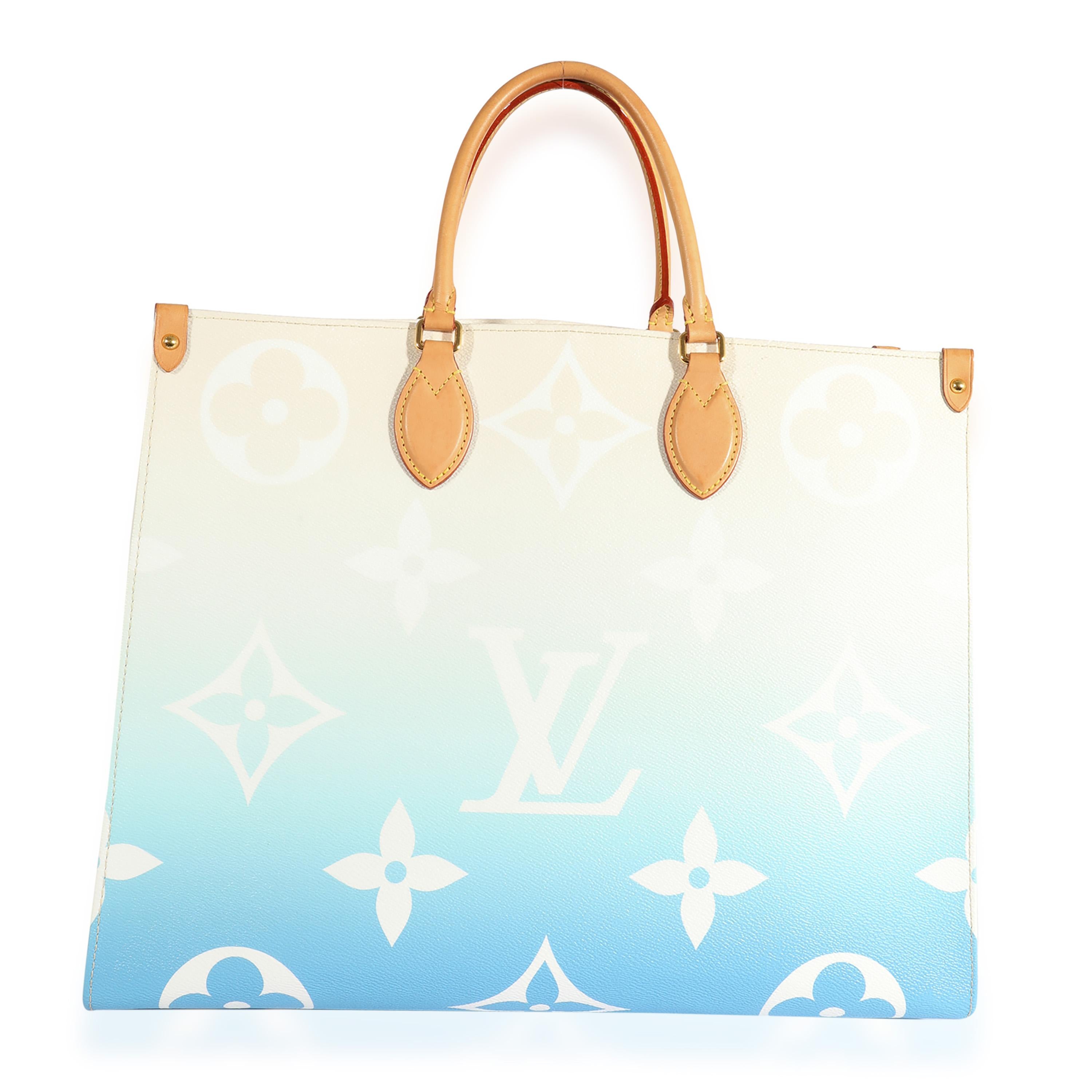 Listing Title: Louis Vuitton Blue Monogram Giant By The Pool Onthego GM
SKU: 124063
Condition: Pre-owned 
Handbag Condition: Very Good
Condition Comments: Very Good Condition. Light scuffing to corners. Light patina and marks to leather trim. Light