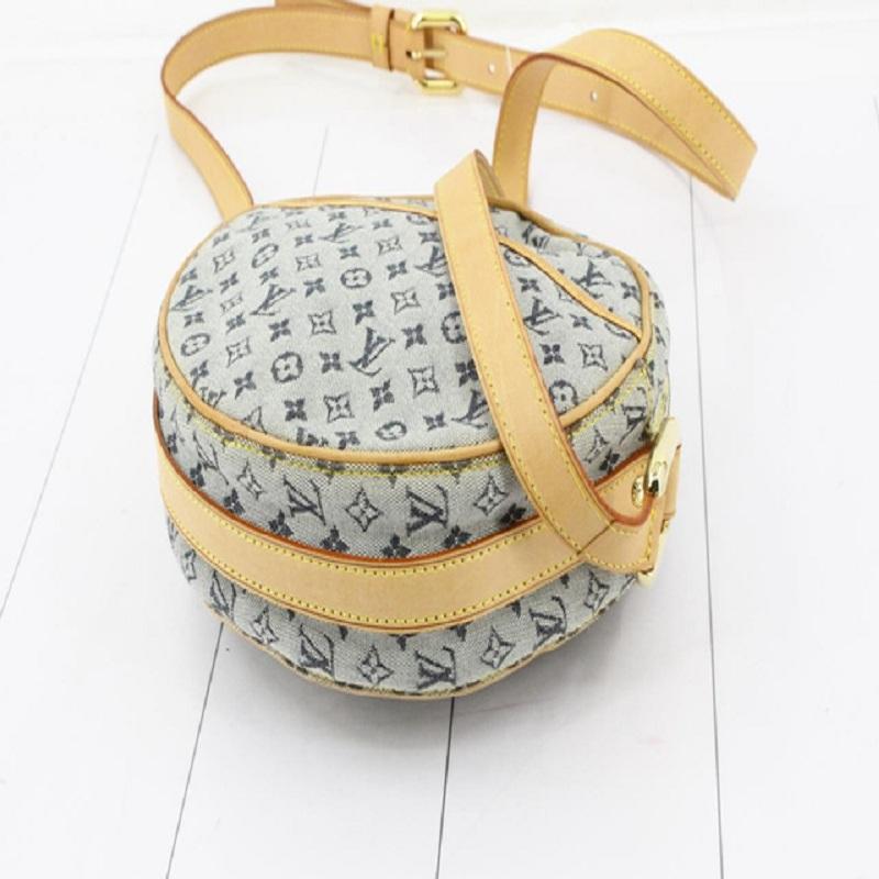 Navy blue monogram canvas Louis Vuitton Mini Lin Jeanne GM with gold-tone hardware, tan vachetta leather trim, one exterior pocket at back, adjustable shoulder strap, neutral woven canvas lining, one pocket at interior wall and zip closure at
