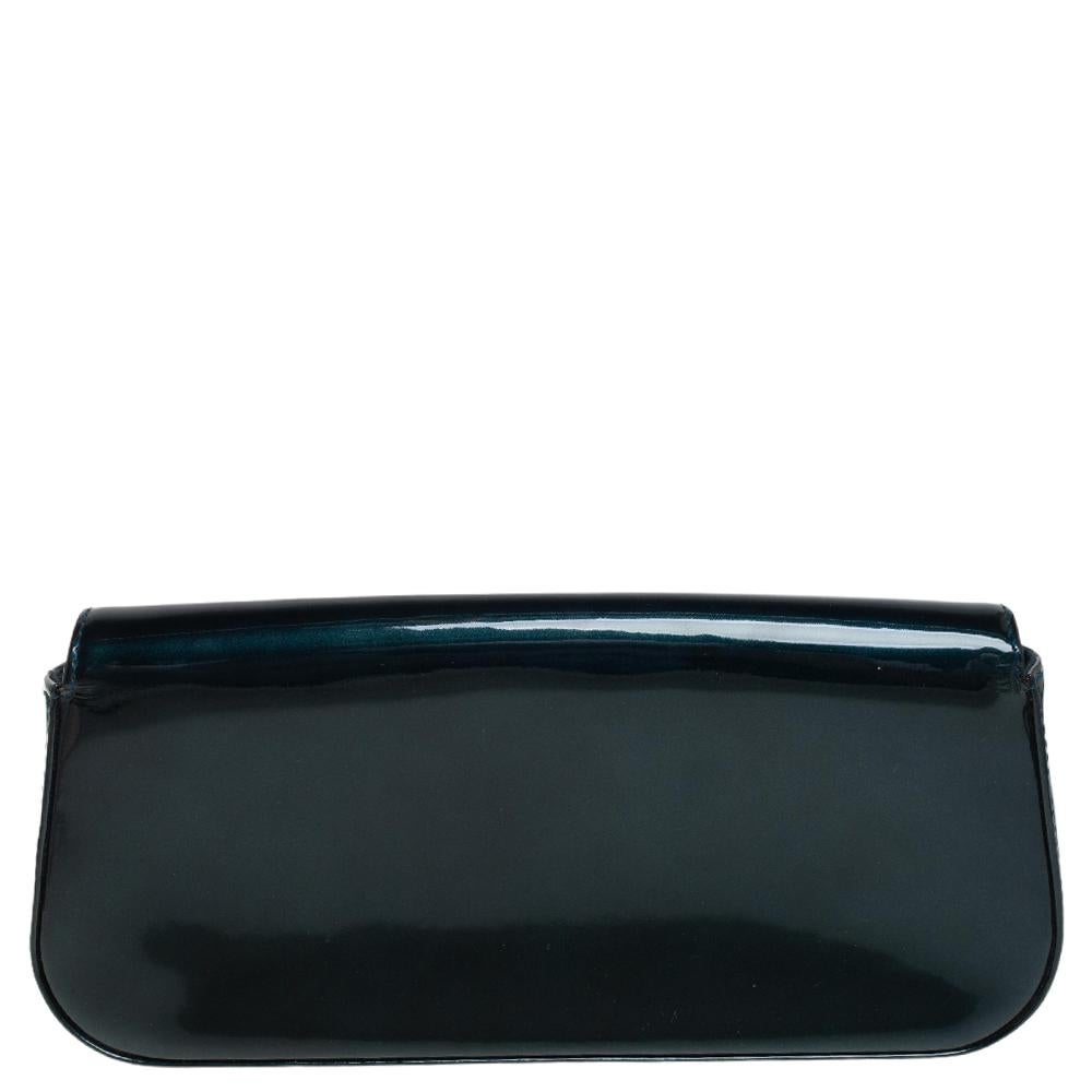 Well-crafted and brimming with sophistication, this Sobe clutch is from Louis Vuitton. It has a patent leather exterior, a fabric interior and an exaggerated LV adorned on the flap. This creation will lift all your gowns and elegant