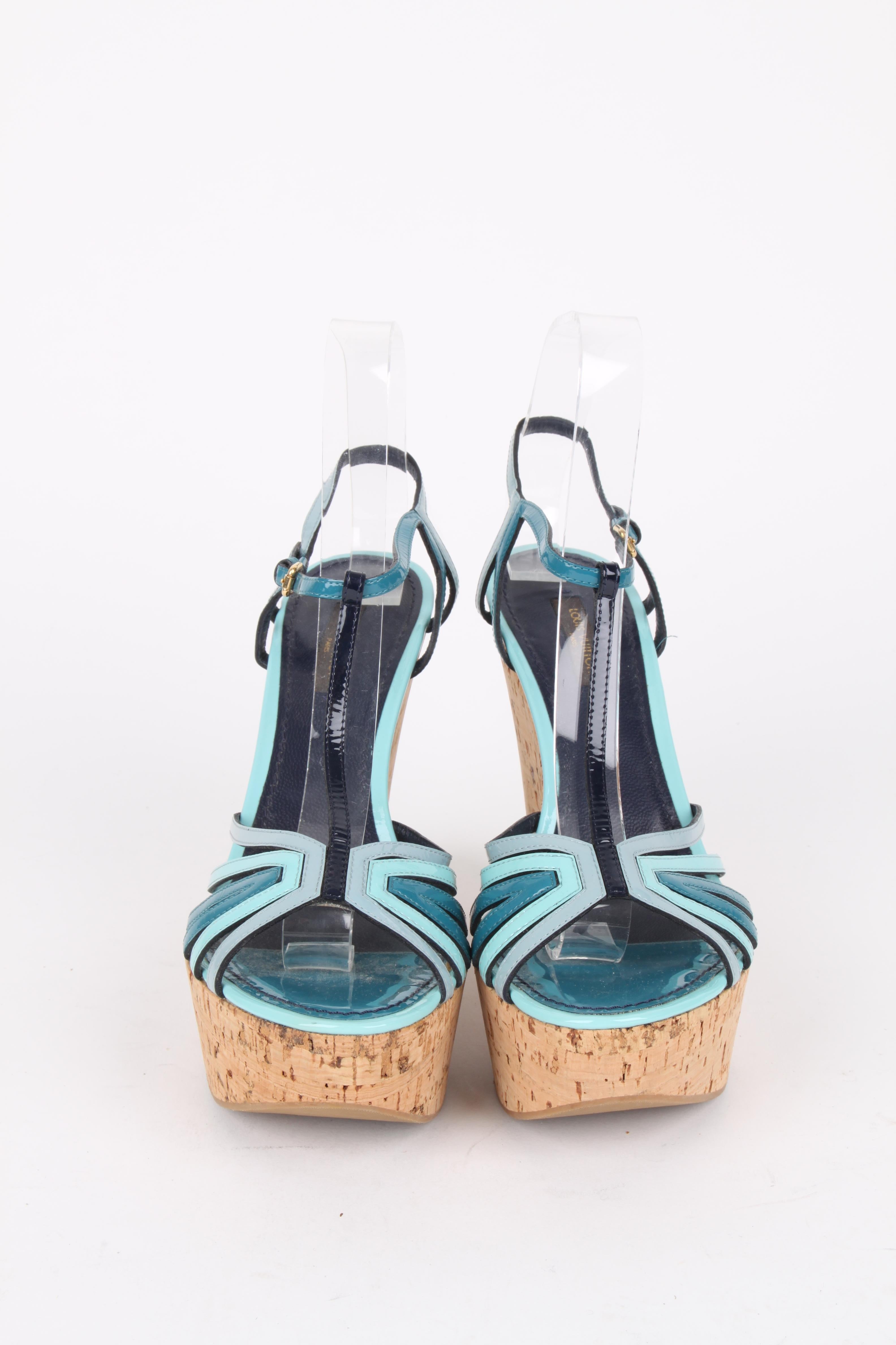 Louis Vuitton Blue Patent Leather Summertime Cork Wedges.

With a strap inspired patent leather design in shades of blue, these flirty wedges feature stacked 13cm cork wedges with a gold-tone metal label and ankle strap buckle closures. The rubber