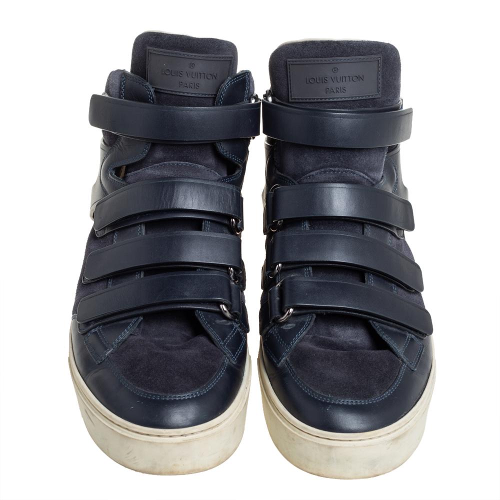 Bring home the luxurious high-fashion touch with these high-top sneakers from Louis Vuitton. Crafted from blue suede and leather, these sneakers flaunt round toes, velcro straps across the vamps, brand logo detailing on the exaggerated tongues and