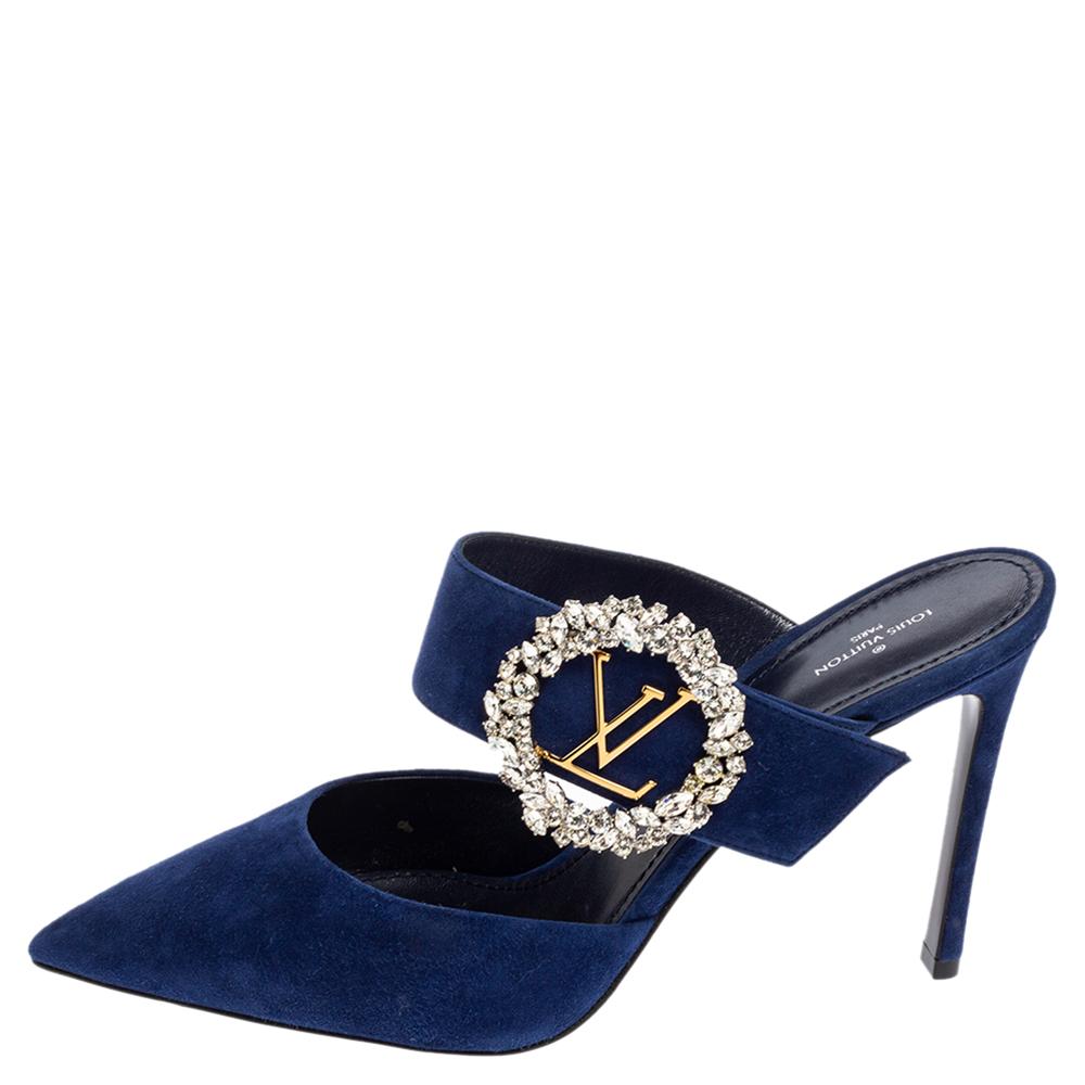 Louis Vuitton's Madeleine mules exude a refined style and sophisticated vibe with their minimal design. Crafted from blue suede, the vamp straps feature the embellished LV logo accents and pointed toes. These beauties are finished off with stiletto