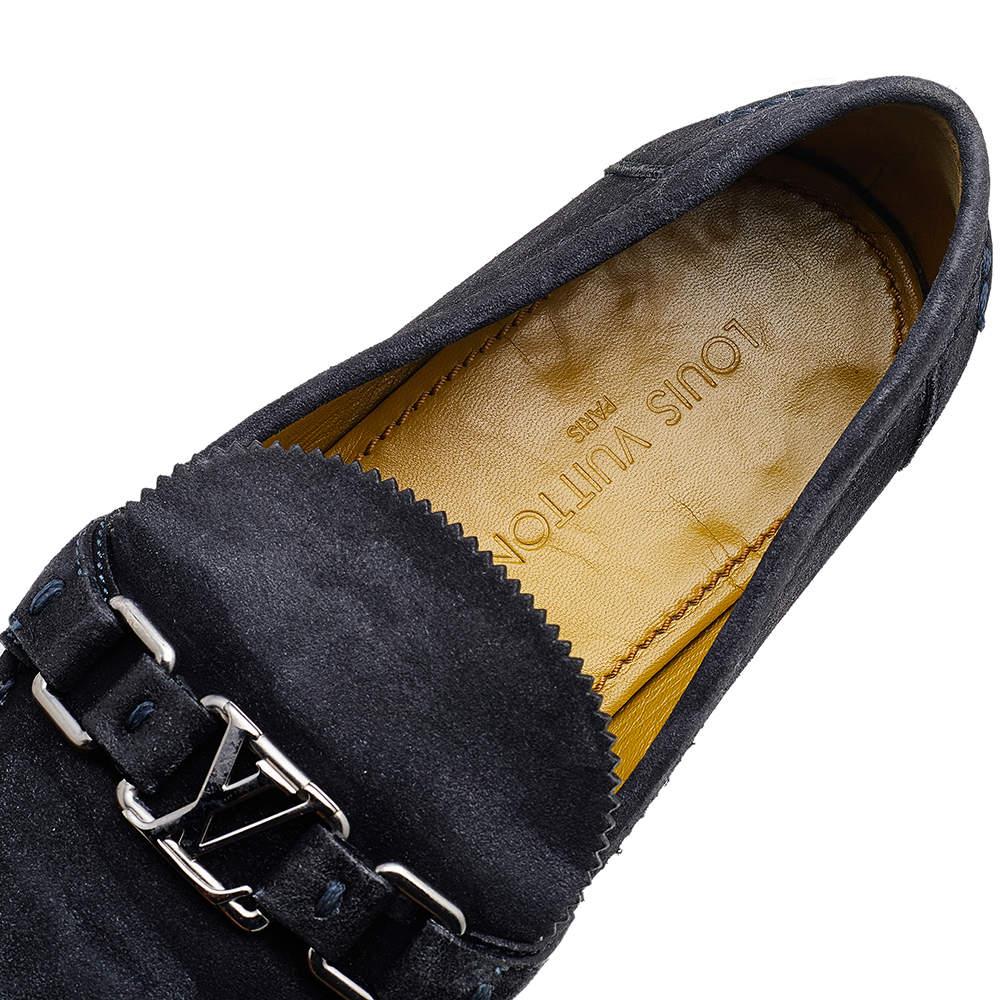 Crafted with beauty using suede, this pair of loafers by Louis Vuitton is a blend of luxury and comfort. They feature the signature LV on the uppers in silver tone, leather-lined insoles and tough soles. The loafers have a luxe structure and are so