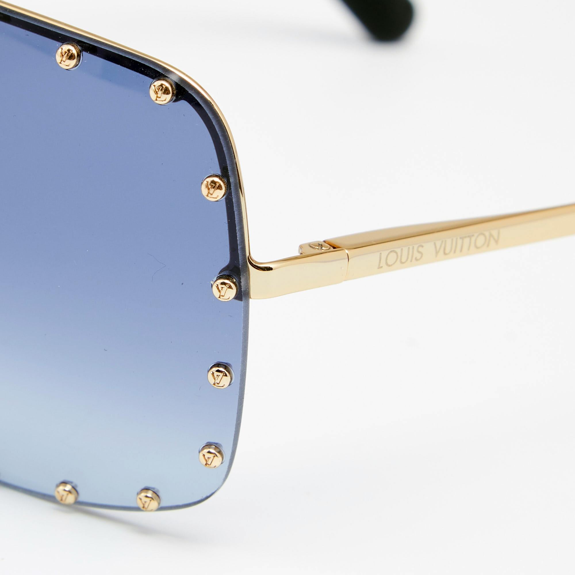 Add a statement finish to your look of the day with these Louis Vuitton The Party square sunglasses. The design is set in a gold-tone metal frame, fitted with high-quality blue lenses, and adorned with LV-detailed studs.

Includes: Original Pouch,