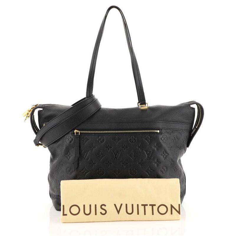 This Louis Vuitton Boetie NM Handbag Monogram Empreinte Leather MM, crafted in black monogram empreinte leather, features dual flat leather handles, exterior zip pocket and gold-tone hardware. Its two-way zip closure opens to a gray fabric interior