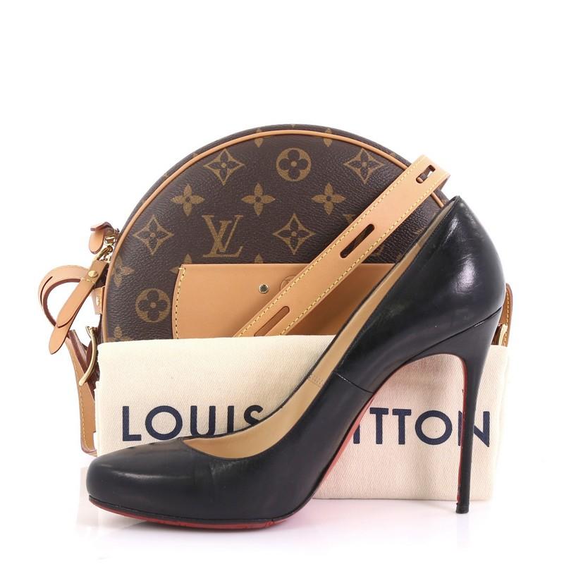 This Louis Vuitton Boite Chapeau Souple Bag Monogram Canvas, crafted from brown monogram coated canvas, features vachetta long leather strap and trim, exterior slip pocket, and gold-tone hardware. Its zip closure opens to a brown microfiber interior