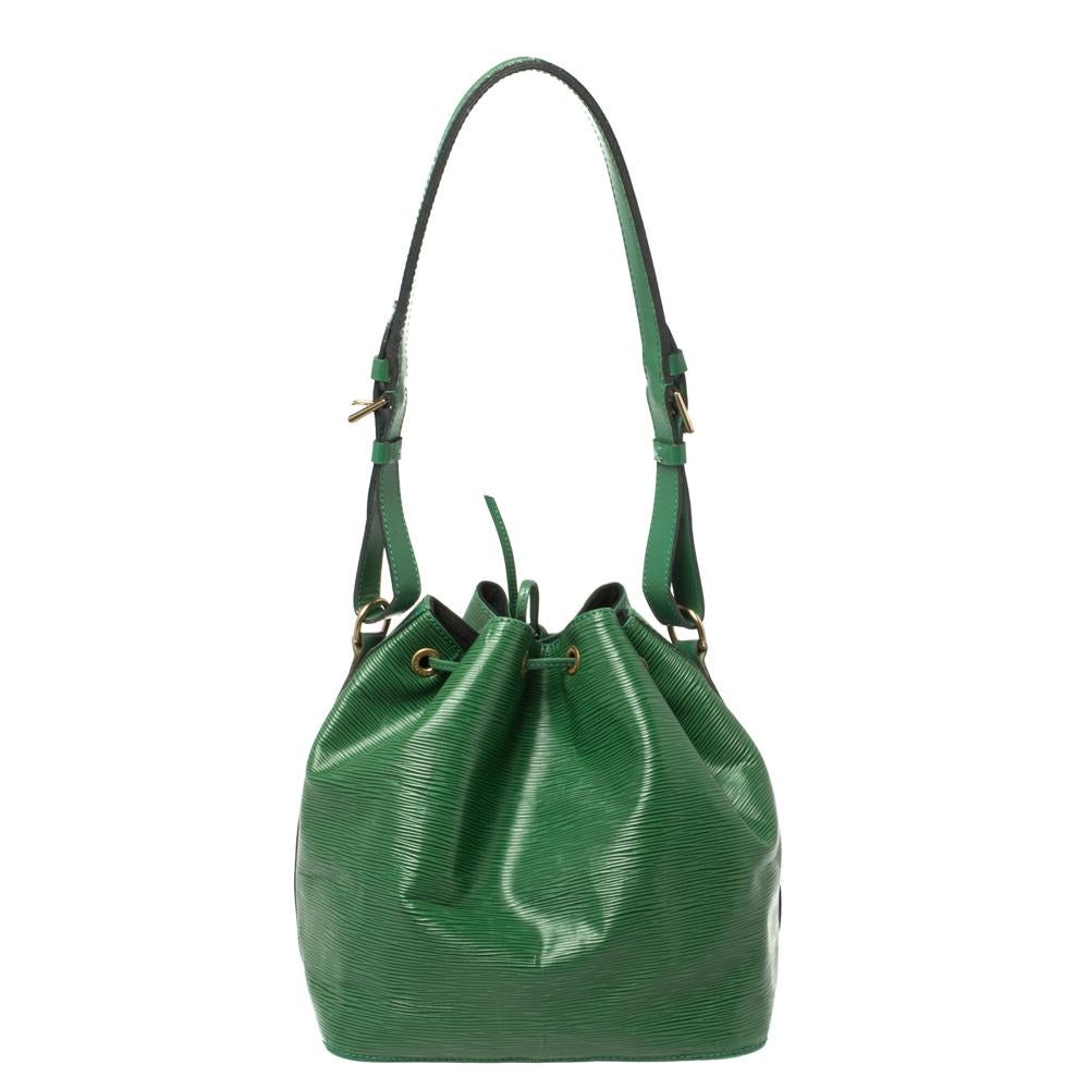 Designed in 1995 by Louis Vuitton, the iconic Noe now serves as a stylish daytime handbag. Crafted from green epi leather, the bag exudes just the right amount of sophistication and class. It has an adjustable strap with gold-tone buckles, a