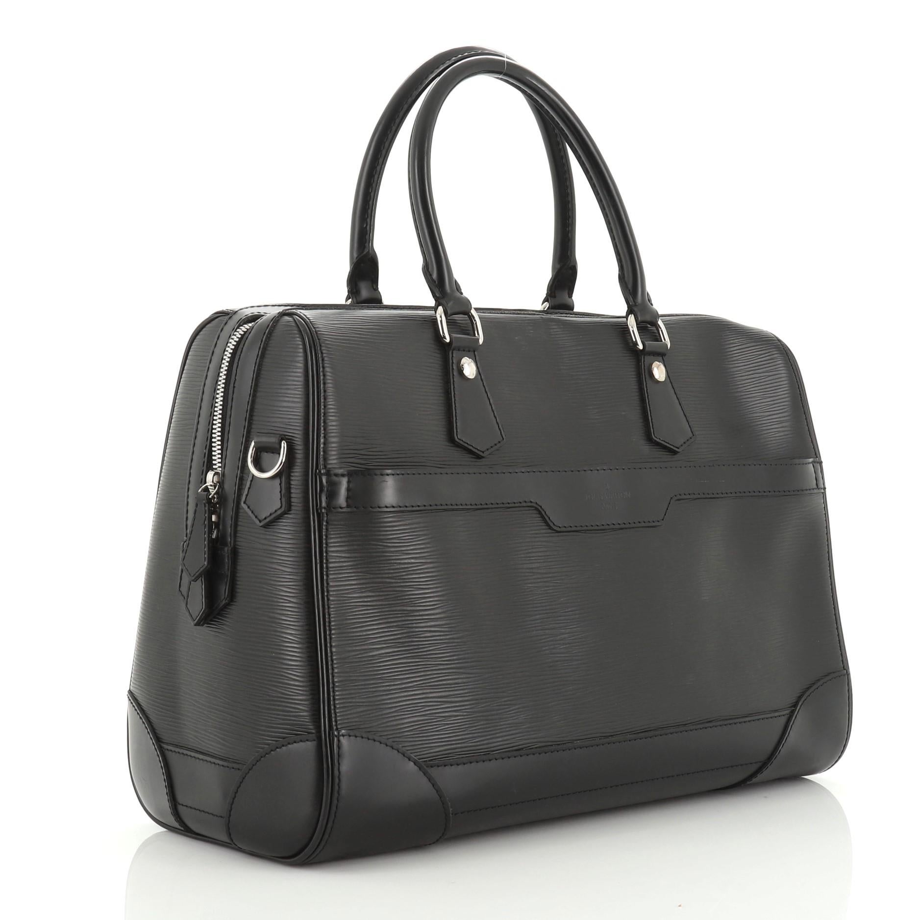 This Louis Vuitton Bourget Duffle Epi Leather 40, crafted in black epi leather, features dual rolled leather handles, smooth leather trim, front zip pocket and silver-tone hardware. Its zip closure opens to a black fabric interior with zip and slip