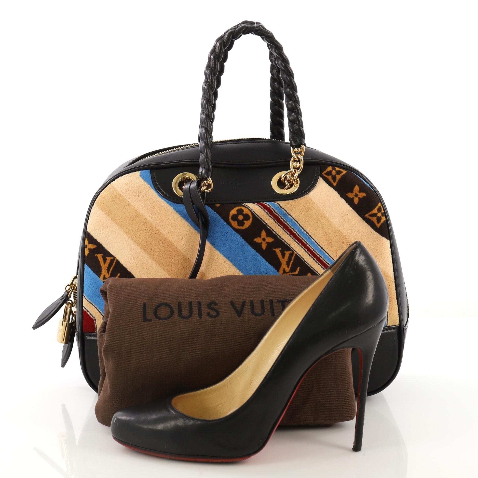 This Louis Vuitton Bowling Vanity Handbag Printed Tuffetage with Leather, crafted from multicolor printed tuffetage with black leather, features chain link straps wrapped in black leather, leather trim, and gold-tone hardware. Its zip closure opens