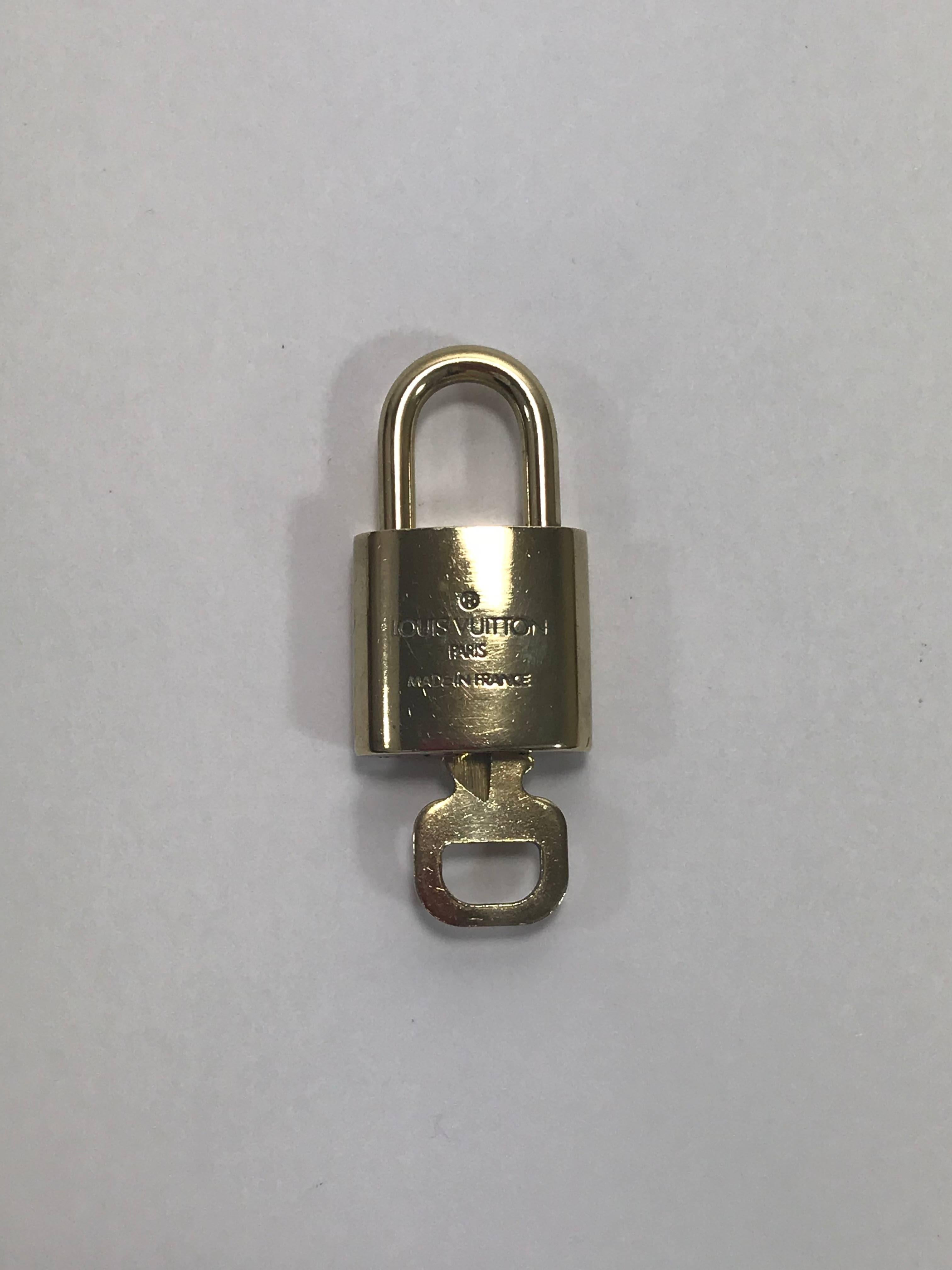 MODEL - Louis Vuitton Brass Lock and Key Set # 305

CONDITION - Exceptional

SKU - 1930

ORIGINAL RETAIL - $175

DIMENSIONS - 1.5 x 1 x .25

MATERIAL - Brass

COMES WITH - No additional accessories

ADDITIONAL INFORMATION - For a bit more security