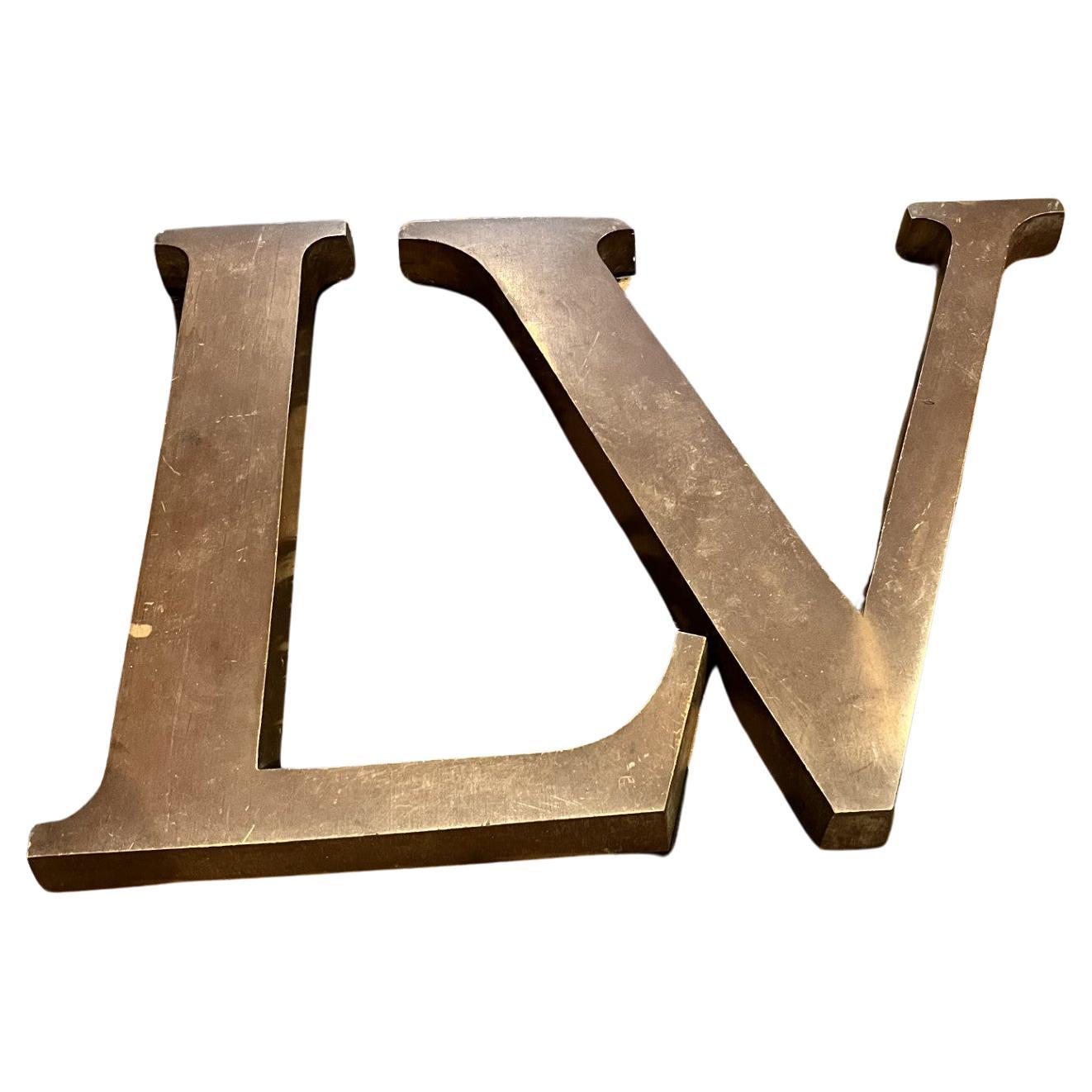Hardly ever seen Original bronze letters from renovation of a Louis Vuitton store in Paris France. This came to the US from France over 25 years ago. Very Large and HEAVY, 5 lbs or 2.26Kg each. 
I could not list sizes for both Letters L is 12' x 8