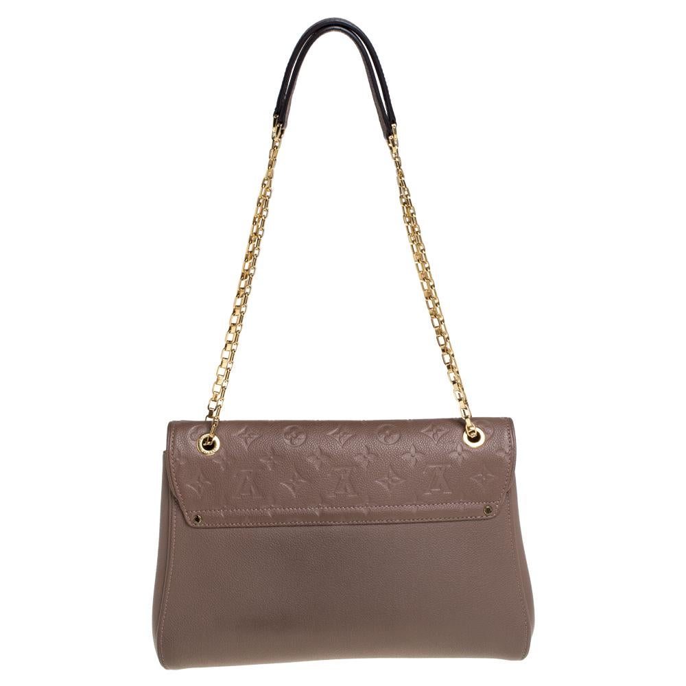 A perfect bag to instantly get recognized is this St Germain bag from Louis Vuitton. Crafted in beige leather, the flap of this pretty bag is embossed with the signature monogram pattern along with a gold-tone S-lock closure. The Alcantara-lined