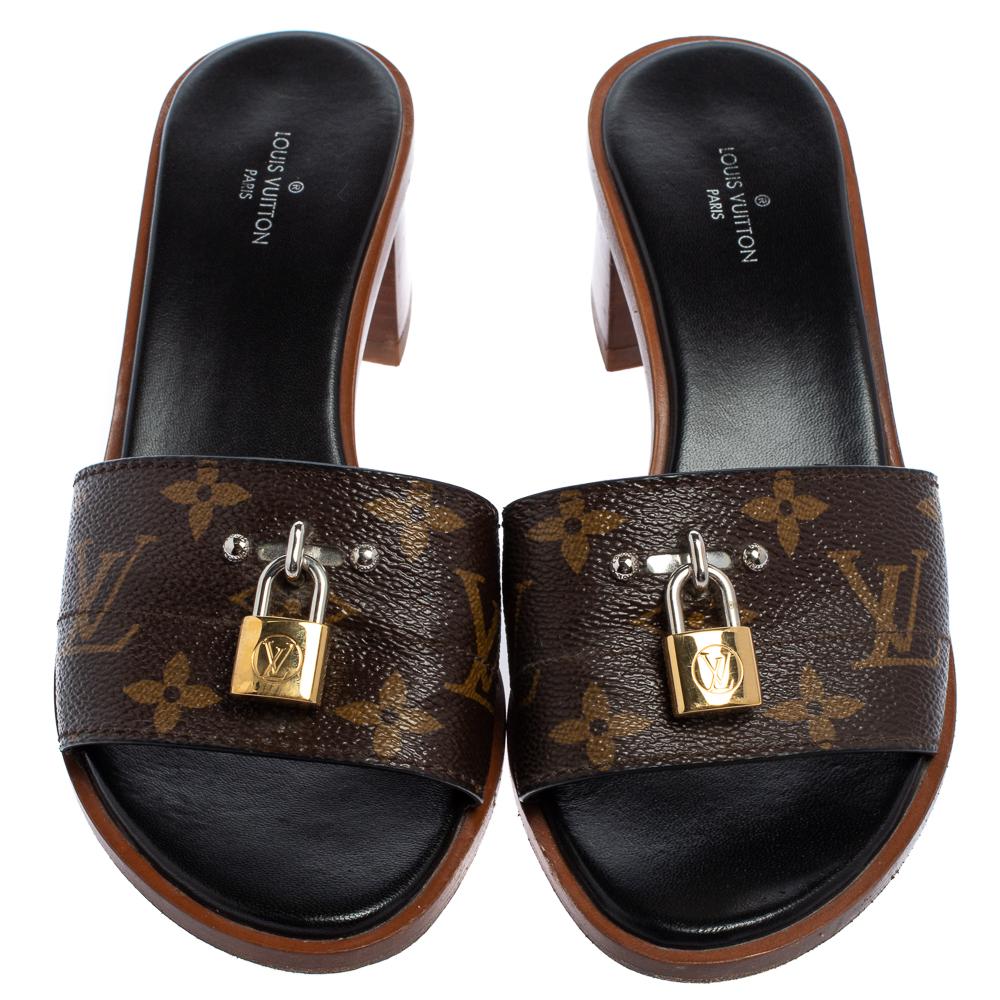 Present your feet with utmost comfort by choosing these 'Lock It' slide sandals from the iconic house of Louis Vuitton! They are crafted from the signature monogram canvas and detailed with gold-tone 'LV' padlocks on the vamp straps. They are