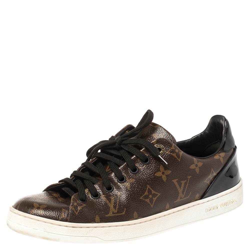 Team these trendy Louis Vuitton low top sneakers with your casual outfits. Crafted in Italy, they are made from the brand's Monogram canvas and black patent leather. They are styled with lace-up fronts, round toes, gold-tone hardware, and signature