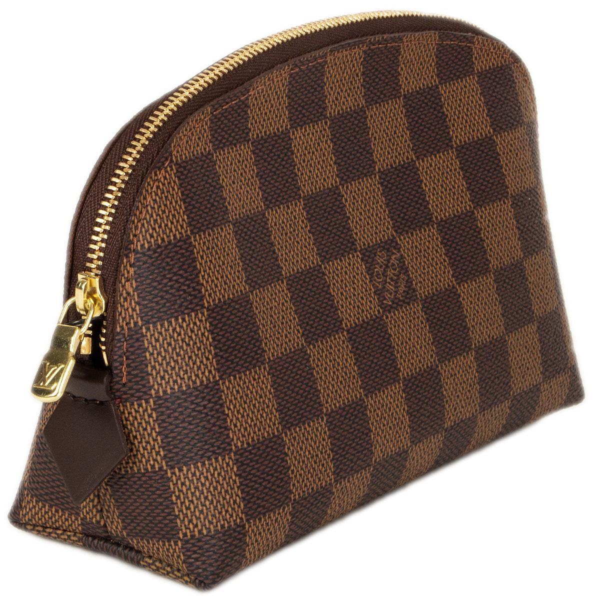 100% authentic Louis Vuitton cosmetic pouch in Damier Ebene canvas with sumptuous leather trimmings, and gold brass detail. Lined in red coated canvas with one slit pocket. Has been carried once and is in virtually new condition.