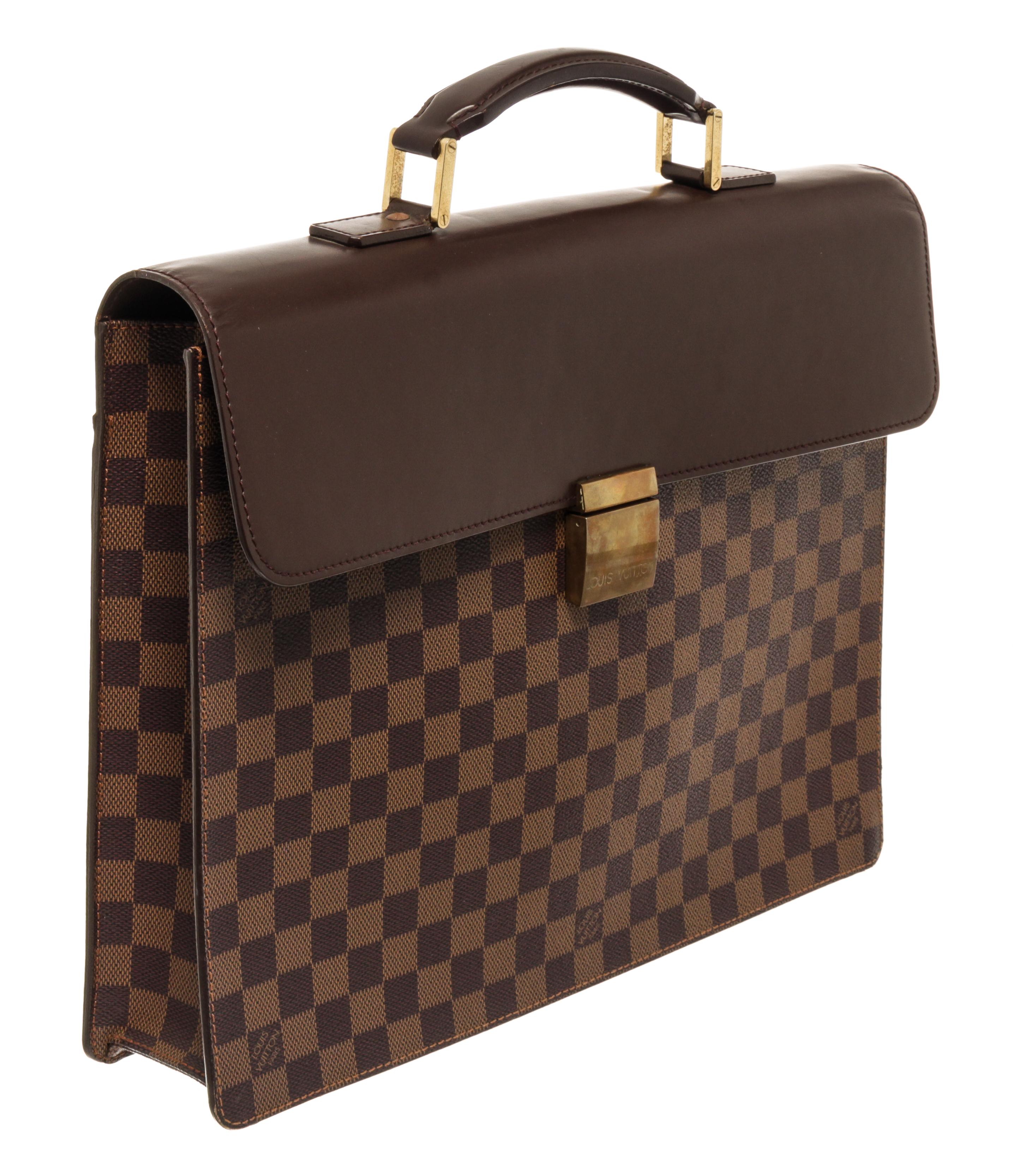 Louis Vuitton Brown Damier Ebene Altona PM Briefcase with gold tone hardware, with brown leather trim, brown suede lining, interior open pockets, with a buckle closure.

77819MSC