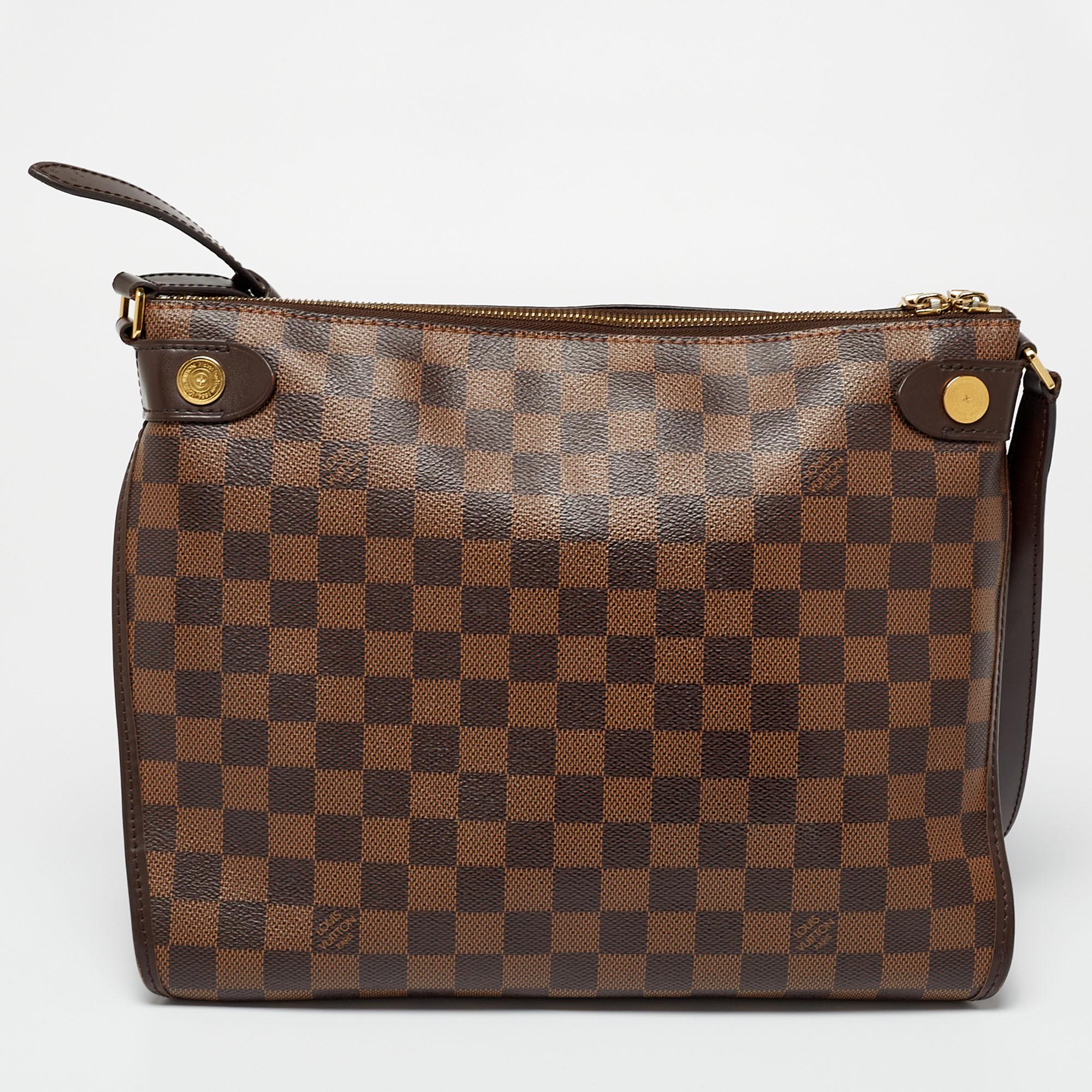 You're sure to fall in love with this bag from Louis Vuitton. Crafted from coated canvas, it flaunts a structured shape and gold-tone details. It has a spacious fabric-lined interior and is complete with a shoulder strap.

Includes: Original