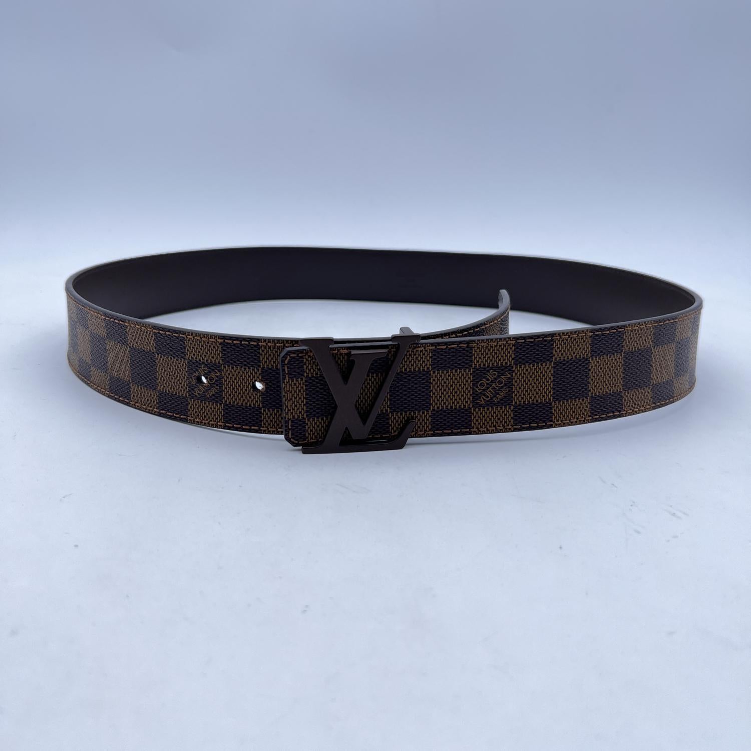 LOUIS VUITTON Brown Damier Ebene Belt . The belt features an LV logo buckle. Five holes adjustment. Size 95/38. Width: 1.5 inches - 4 cm. Total length: 44 inches- 111.7 cm. From first notch to buckle: 38.5 inches - 97.8 cm. From last notch to