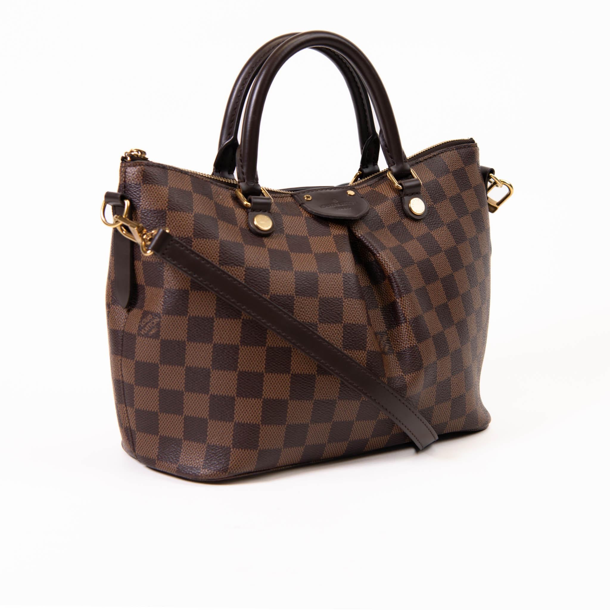 100% Authentic 

Make a brilliant appearance with this matchless bag by Louis Vuitton. The ever-classic spacious handbag is constructed from Damier Ebene canvas and lined with fabric. The interior is spacious and the two handles are easy to hold.